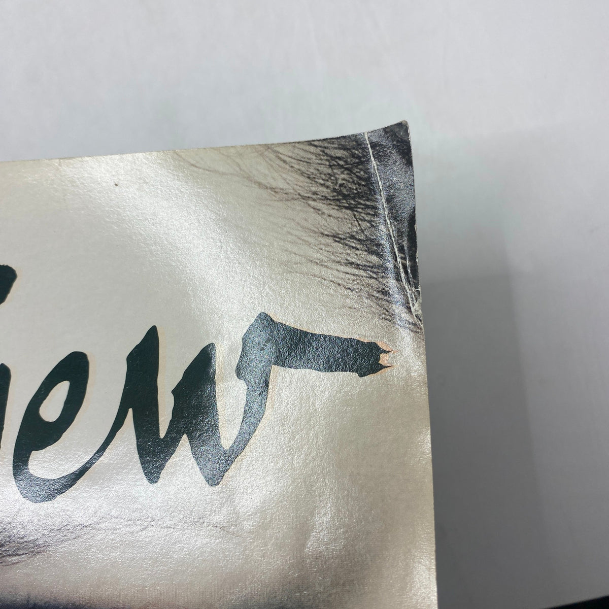 Detail of the top edge of Interview Magazine November 2009 showing minor wear and tear, highlighting its vintage character.