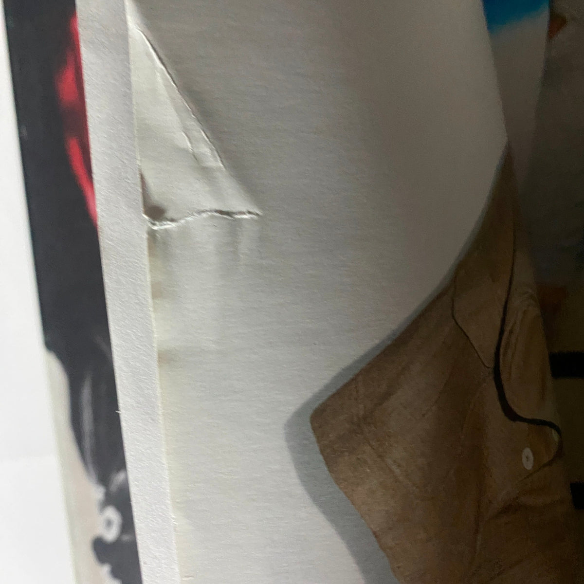Detailed view of the spine of Interview Magazine April 2011, highlighting a minor tear, demonstrating the vintage condition of this collectible magazine featuring Lil Wayne's World by Paris Hilton.