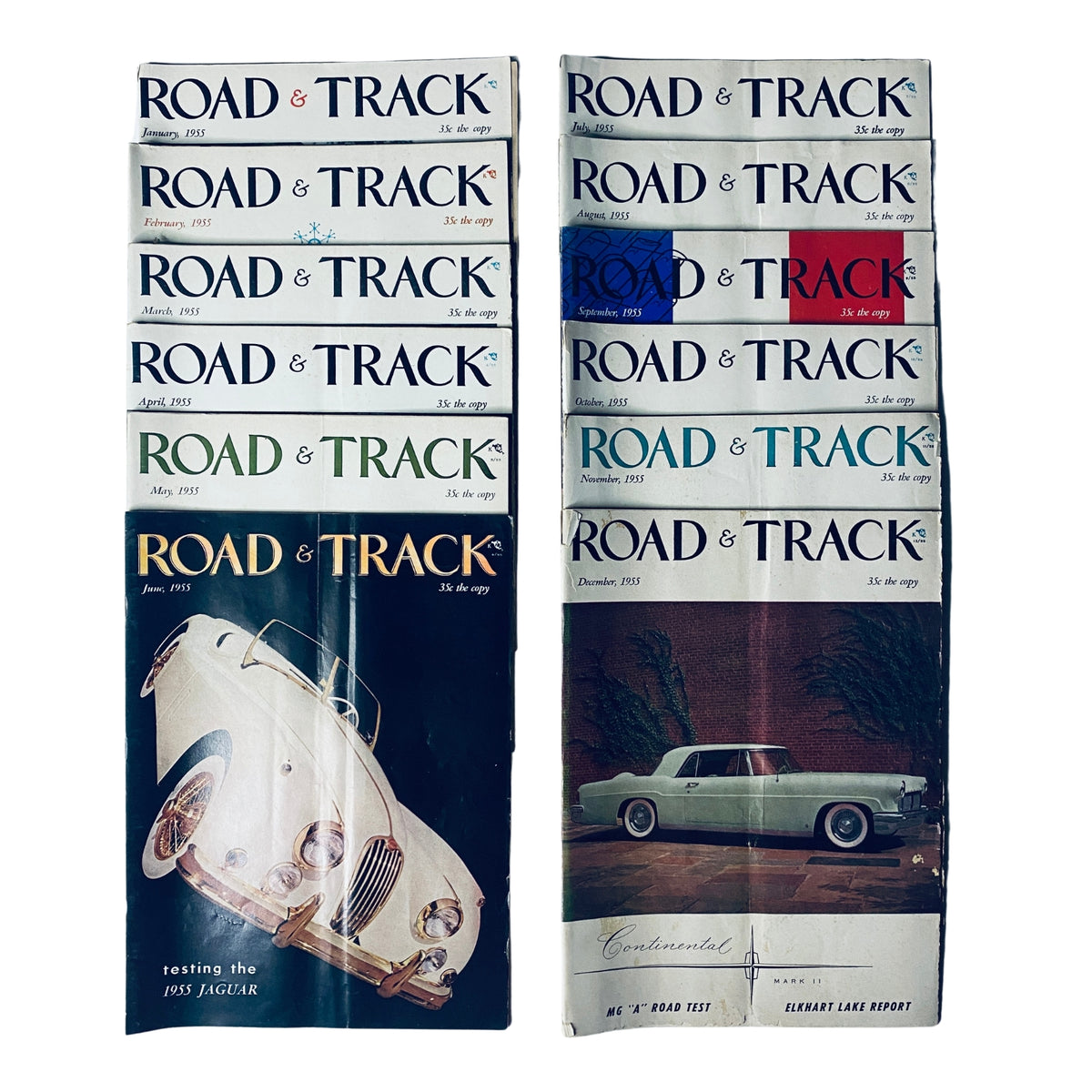 Lot of 12 Road & Track Magazines 1955 showcasing covers from January to December, featuring classic car designs and racing themes, perfect for vintage car enthusiasts.