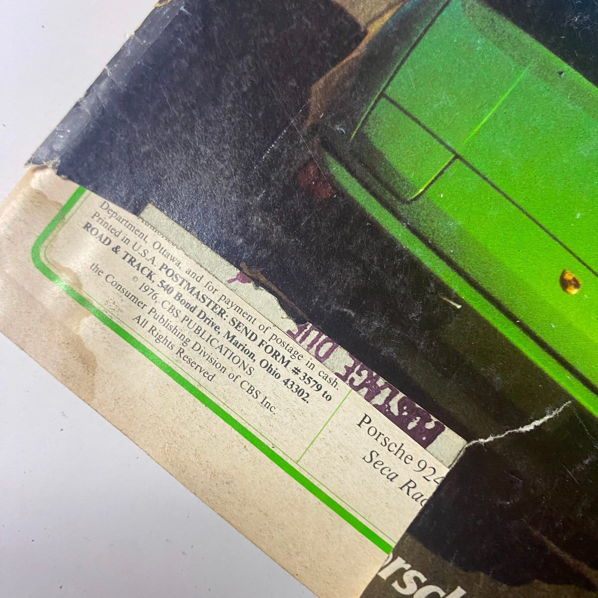 Close-up of a vintage Road & Track magazine page from 1976, showing details about Porsche vehicles.