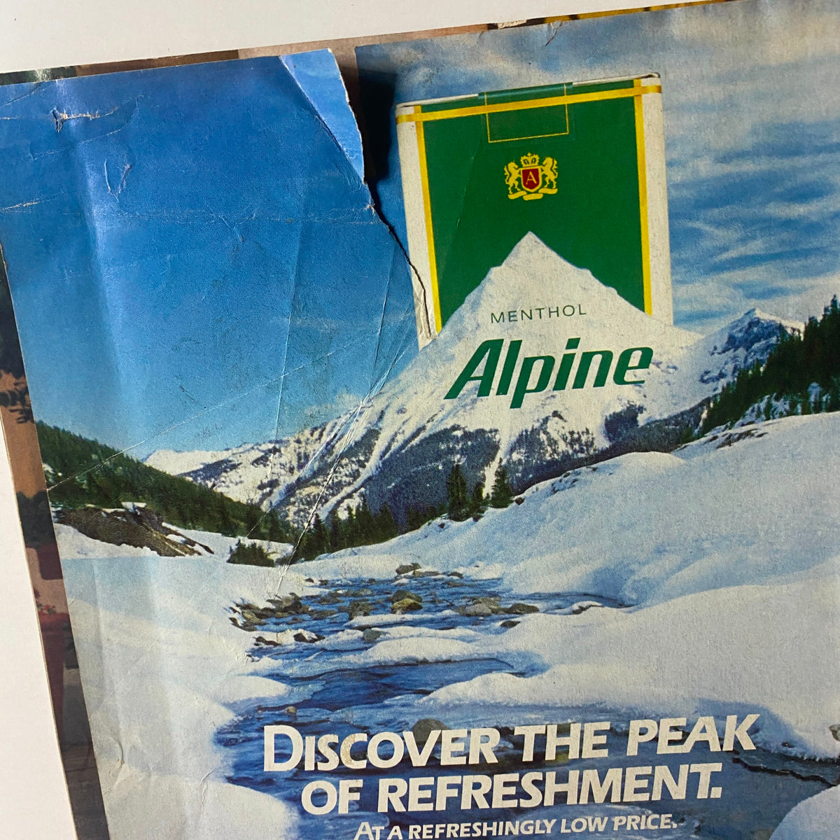 Vintage Newsweek Magazine May 22 1989 featuring a damaged cover with a scenic mountain view and Alpine menthol cigarette advertisement, capturing nostalgic 1980s artwork.