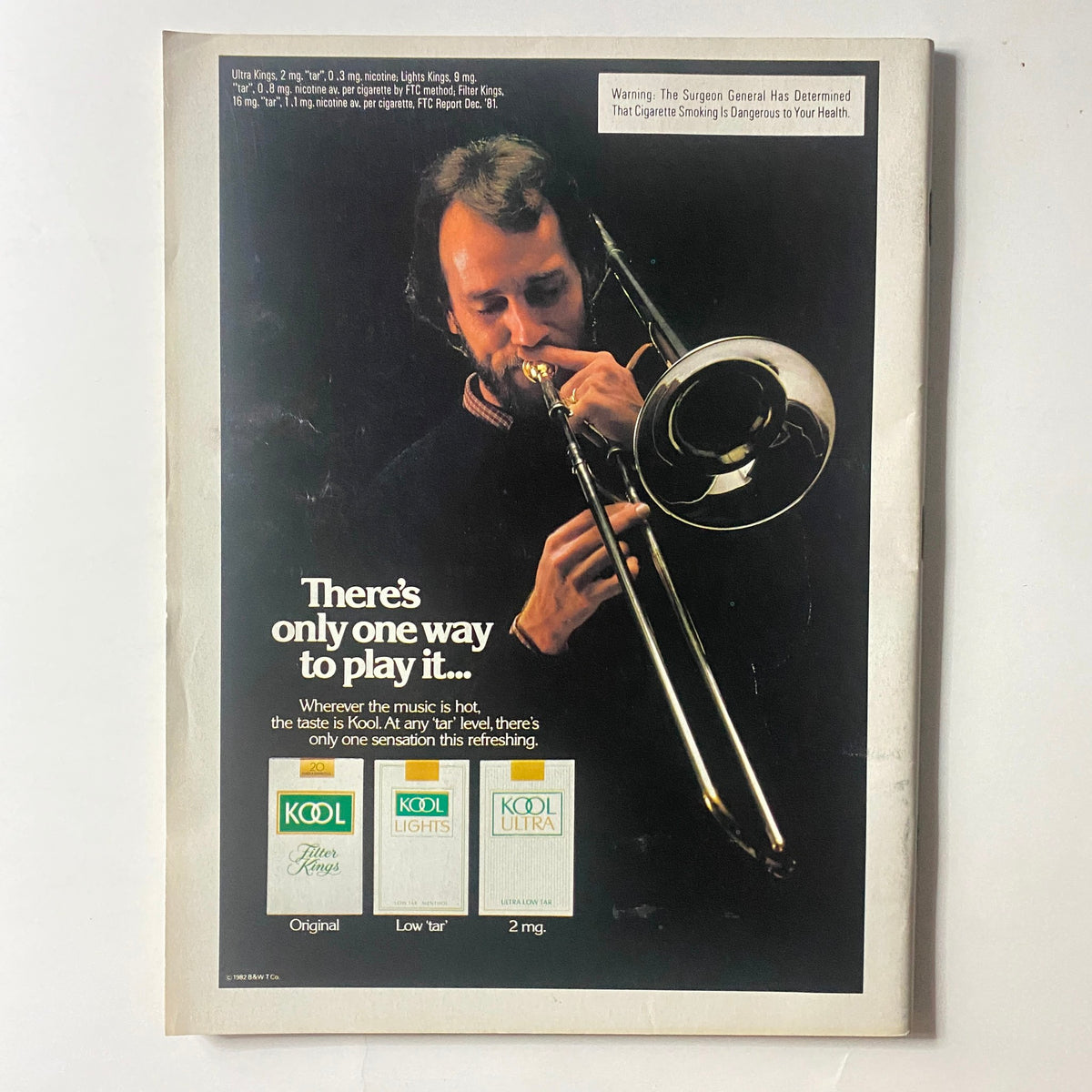 Vintage advertisement from VTG Newsweek Magazine April 19, 1982, promoting Kool cigarettes, showcasing a musician playing a trombone.