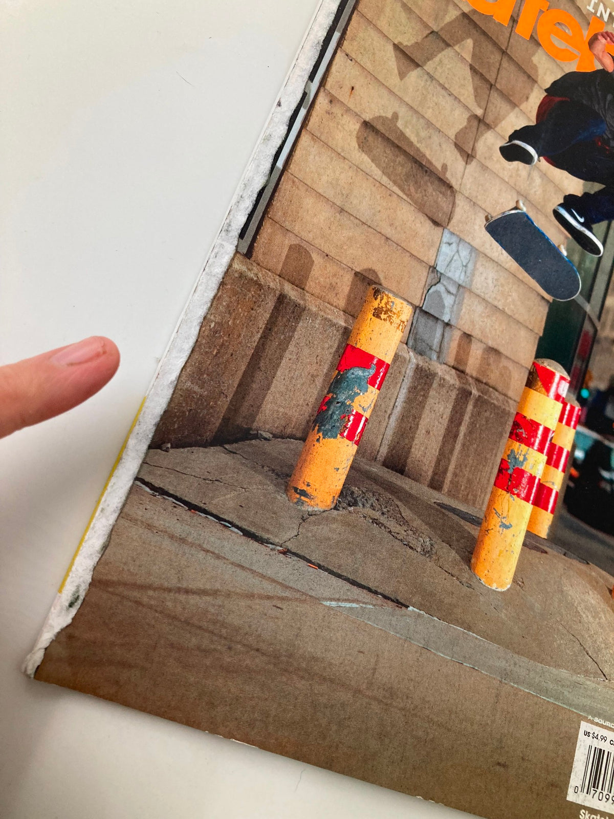 Close-up of the spine of Skateboarder Magazine December 2010, highlighting wear and tear on the magazine's edge, emphasizing its vintage appeal.
