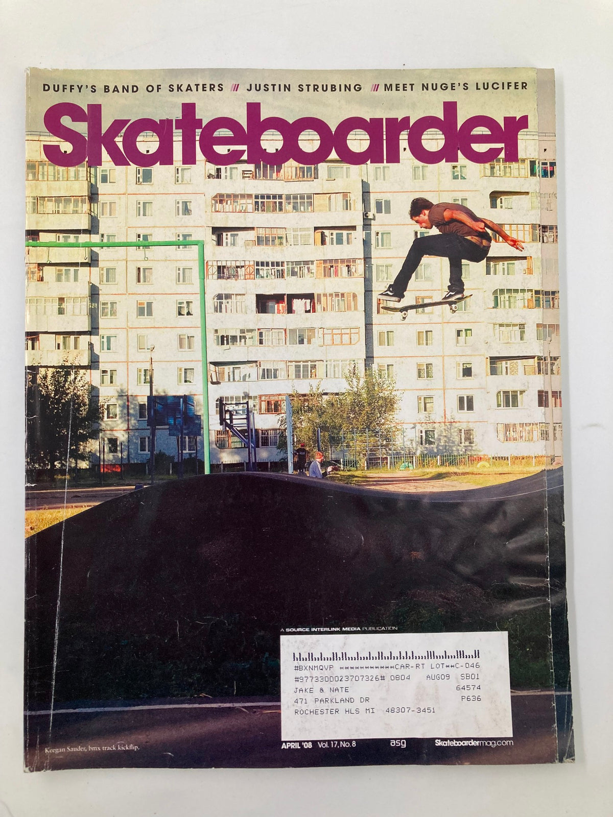 Cover of Skateboarder Magazine April 2008 Vol 17 #8 featuring Keegan Sander performing a kickflip in Omsk, Russia against a backdrop of residential buildings.