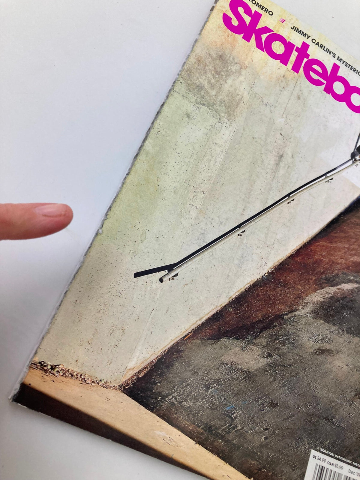 Close-up of the cover of Skateboarder Magazine December 2009 displaying Jerry Hsu's Backside 50-50 Pop-Off with focus on magazine details and wear.