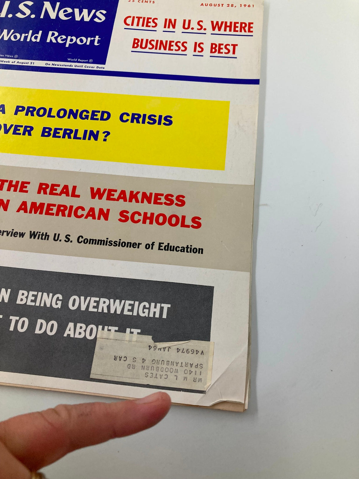 Close-up view of the cover of US News & World Report Magazine dated August 28, 1961, showing details of the stories such as 'A Prolonged Crisis Over Berlin' and information on education.
