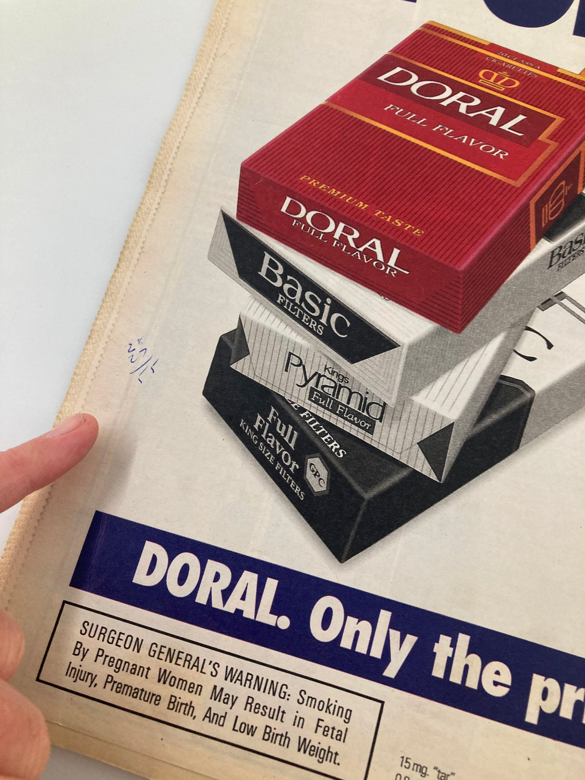 Detail of an advertisement for Doral cigarettes from the National Enquirer Magazine August 16 1994, highlighting health warnings.