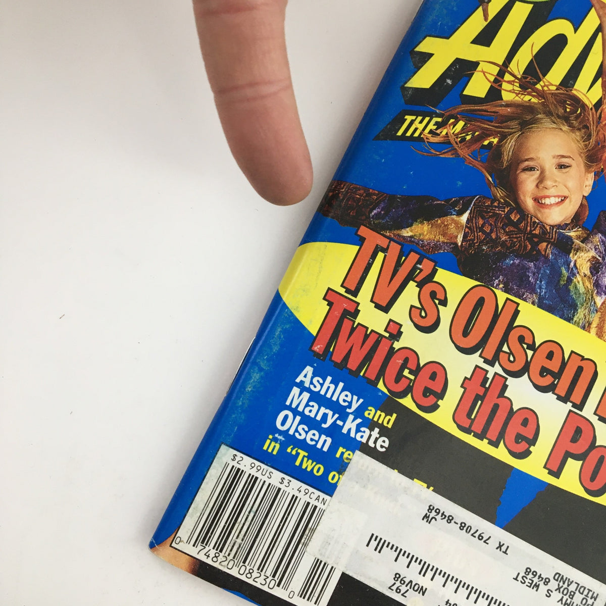 Close-up of the Disney Adventures Magazine, October 1998, highlighting the cover featuring TV's Ashley and Mary Kate Olsen Twins. The image displays details of the magazine's title and the colorful design emphasizing the twins' popularity.