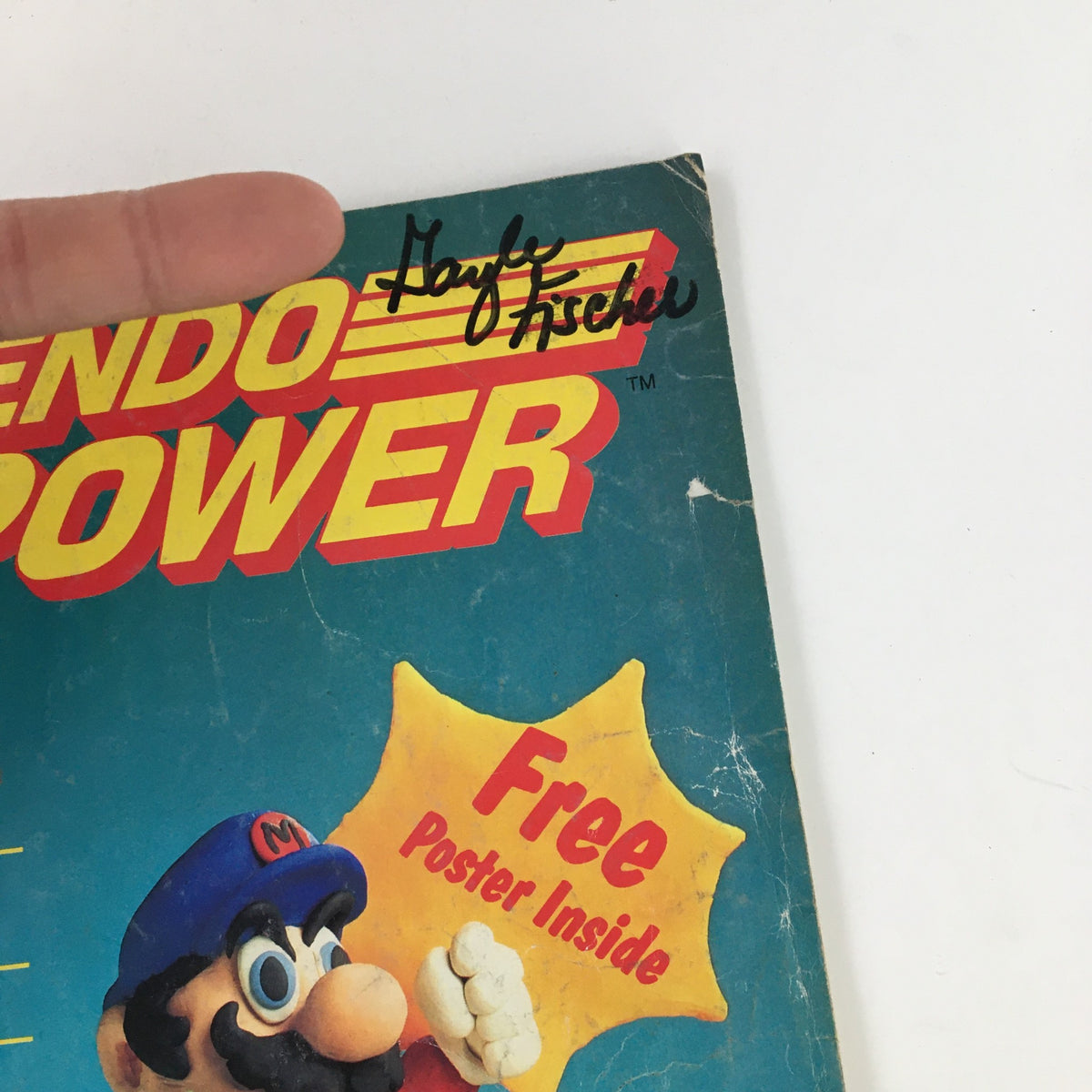 Cover of Nintendo Power Magazine July 1988 featuring Super Mario with promotional text for a free poster, showcasing minor wear and a handwritten signature.
