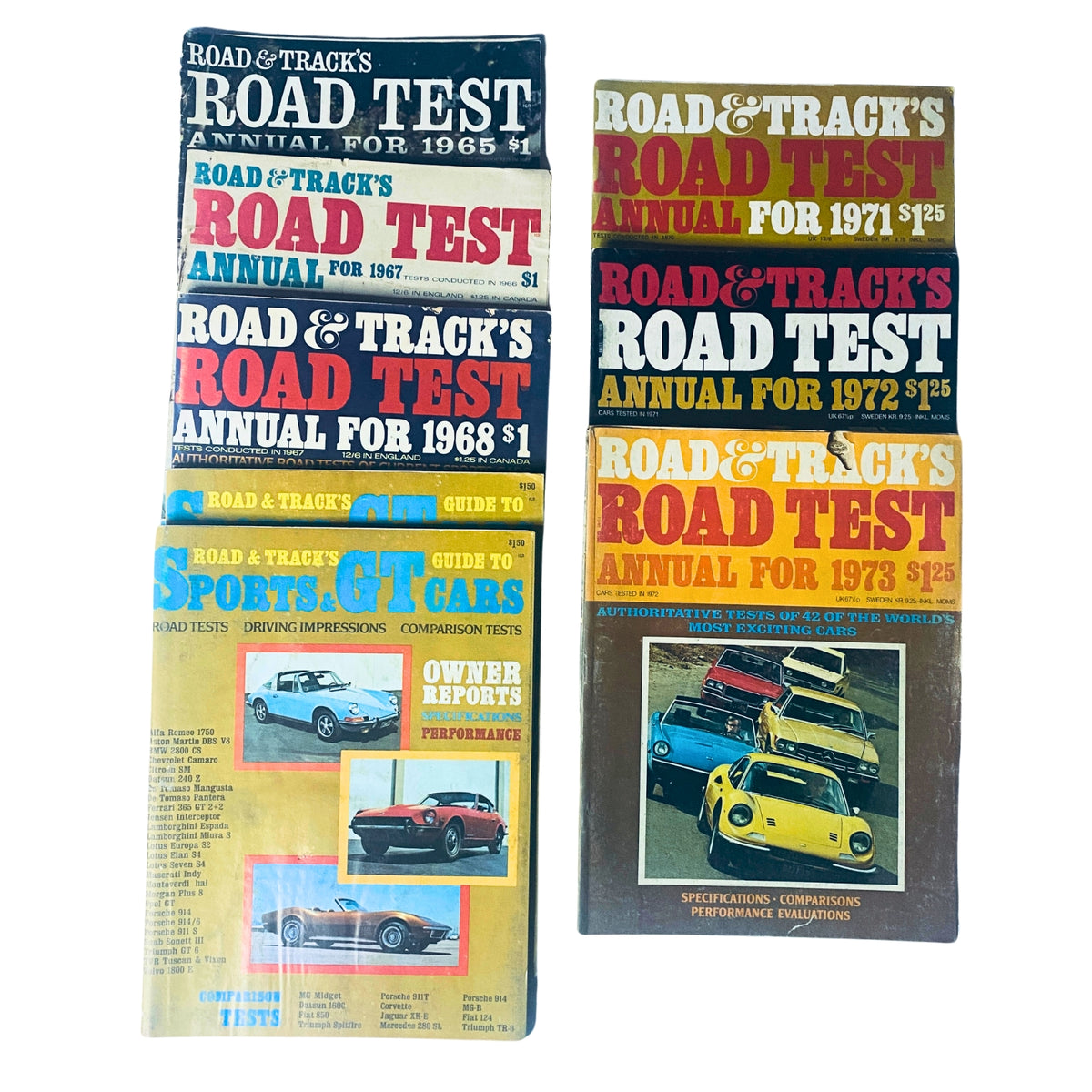 Lot of 8 Road & Track Road Test Annuals from 1965 to 1973 including Sports & GT Cars Guide, showcasing covers of vintage automotive magazines.