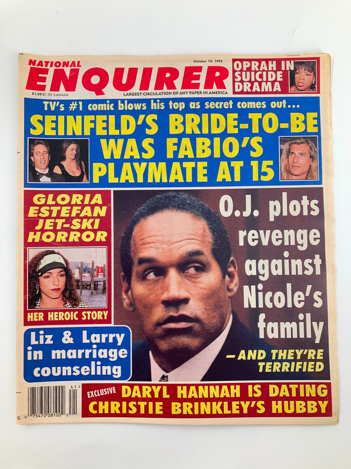 Cover of National Enquirer Tabloid from October 10, 1995 featuring Gloria Estefan, Liz Taylor, and headlines about O.J. Simpson and Daryl Hannah. The tabloid is marked as Very Good condition with a protective covering.