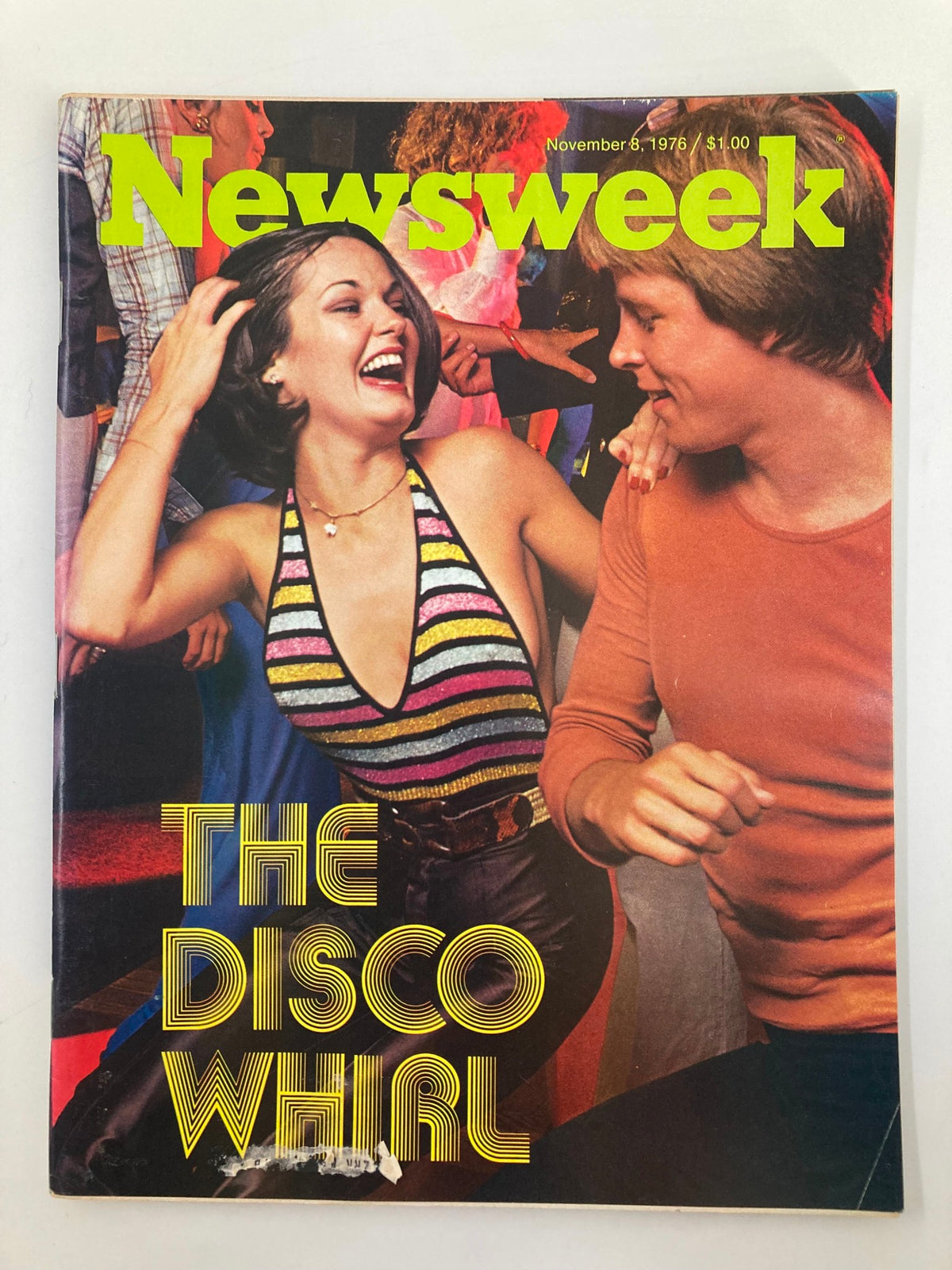 Cover of Newsweek Magazine from November 8, 1976, featuring the theme 'The Disco Whirl of the 70's'. The cover shows a lively scene capturing the joy of disco dancing, with a smiling woman in a colorful top and a man enjoying the moment.