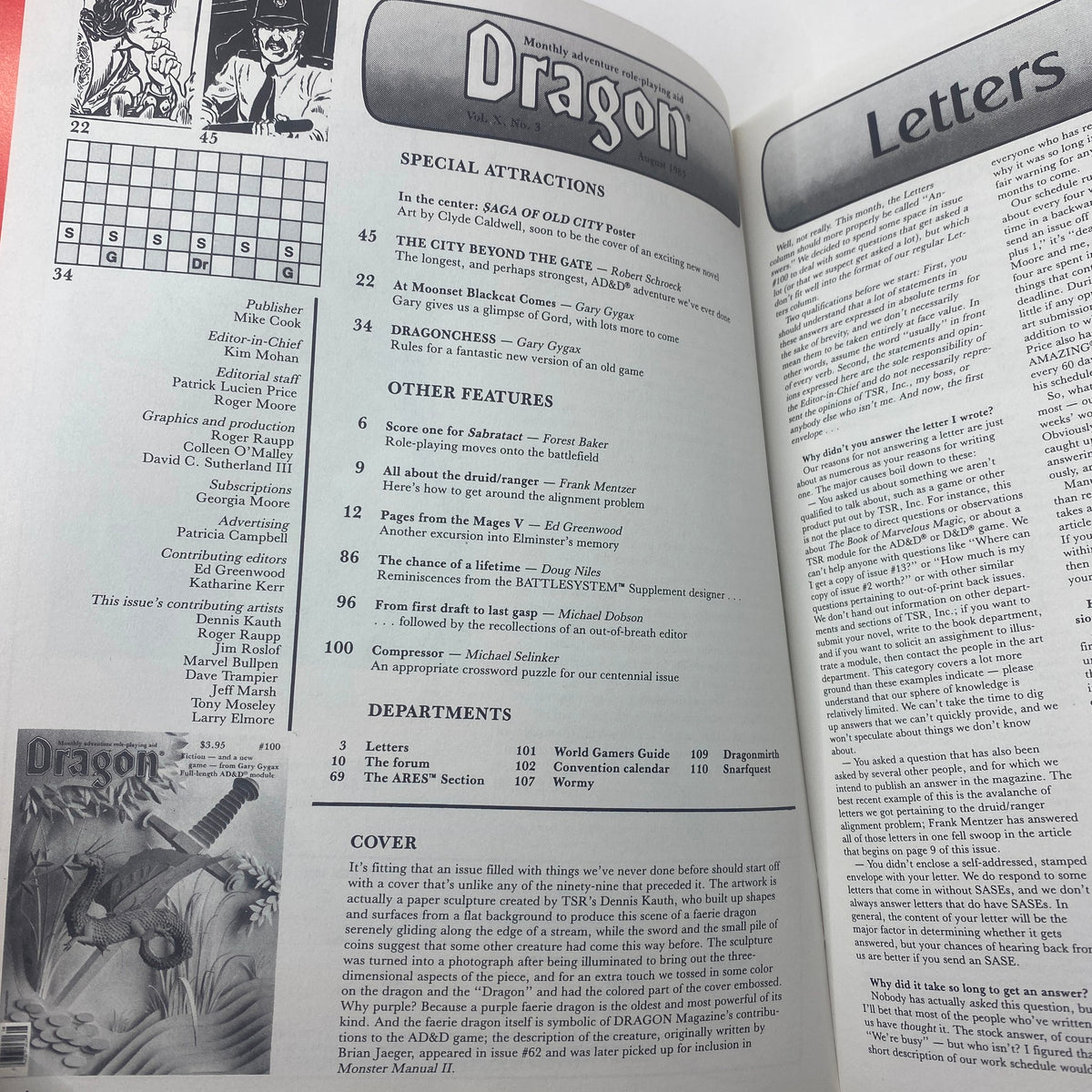 Inside spread of VTG Dragon Magazine August 1985 Issue #100 displaying special features, articles, and a crossword puzzle related to RPGs, highlighting its content for role-playing game enthusiasts.