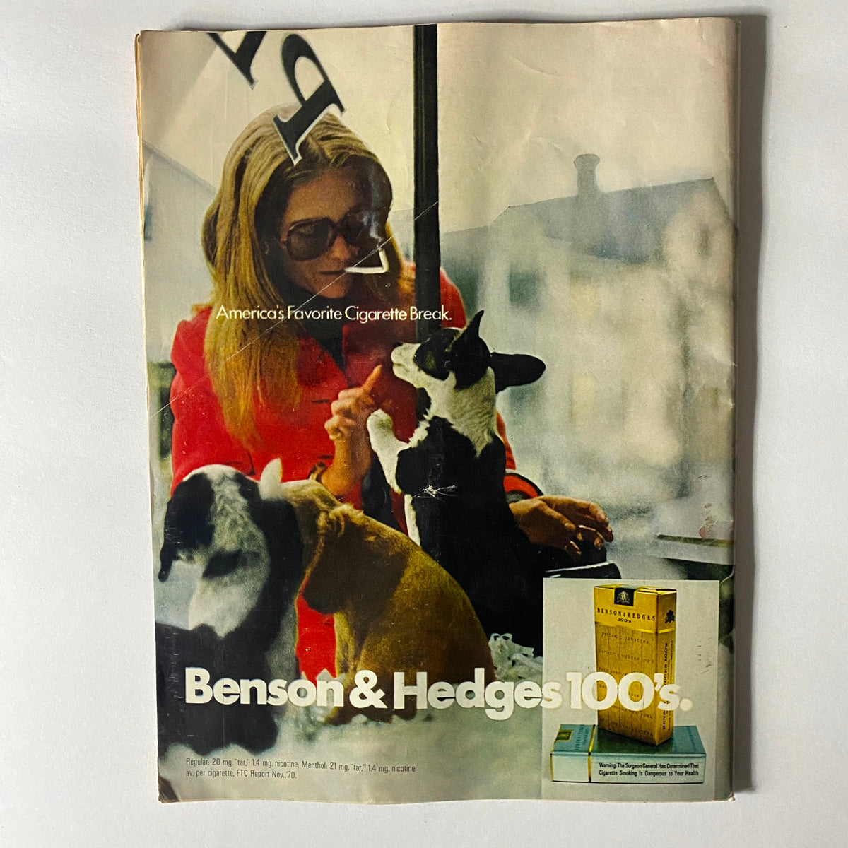 Vintage advertisement for Benson & Hedges cigarettes featuring a woman with sunglasses and dogs, titled 'America's Favorite Cigarette Break'.