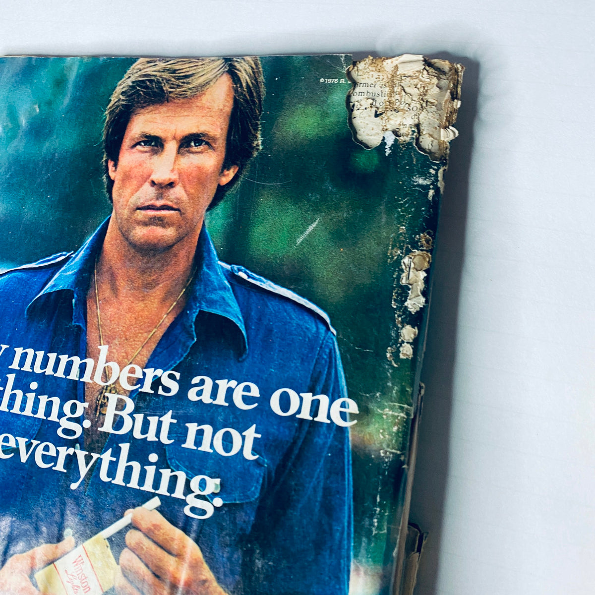 Cover of Road & Track Magazine from February 1977 featuring a man in a blue shirt and a damaged top corner. Title: Lot of 10 Road & Track Magazine 1977 February, March, May, June, August-December.
