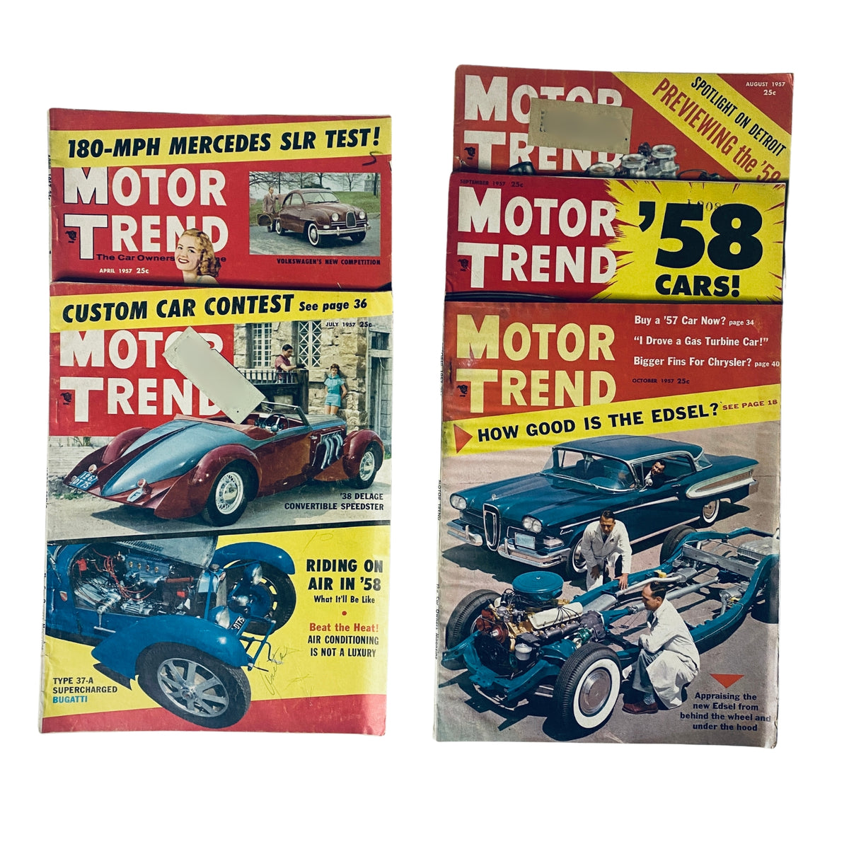Lot of 5 Motor Trend Magazines including April 1957 and July to October issues featuring automotive content and vintage advertisements.