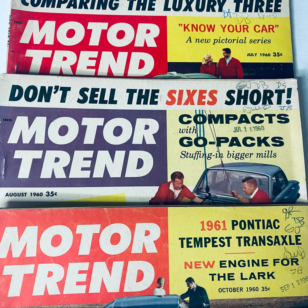 August and October 1960 covers of Motor Trend Magazine highlighting automotive topics and car comparisons.