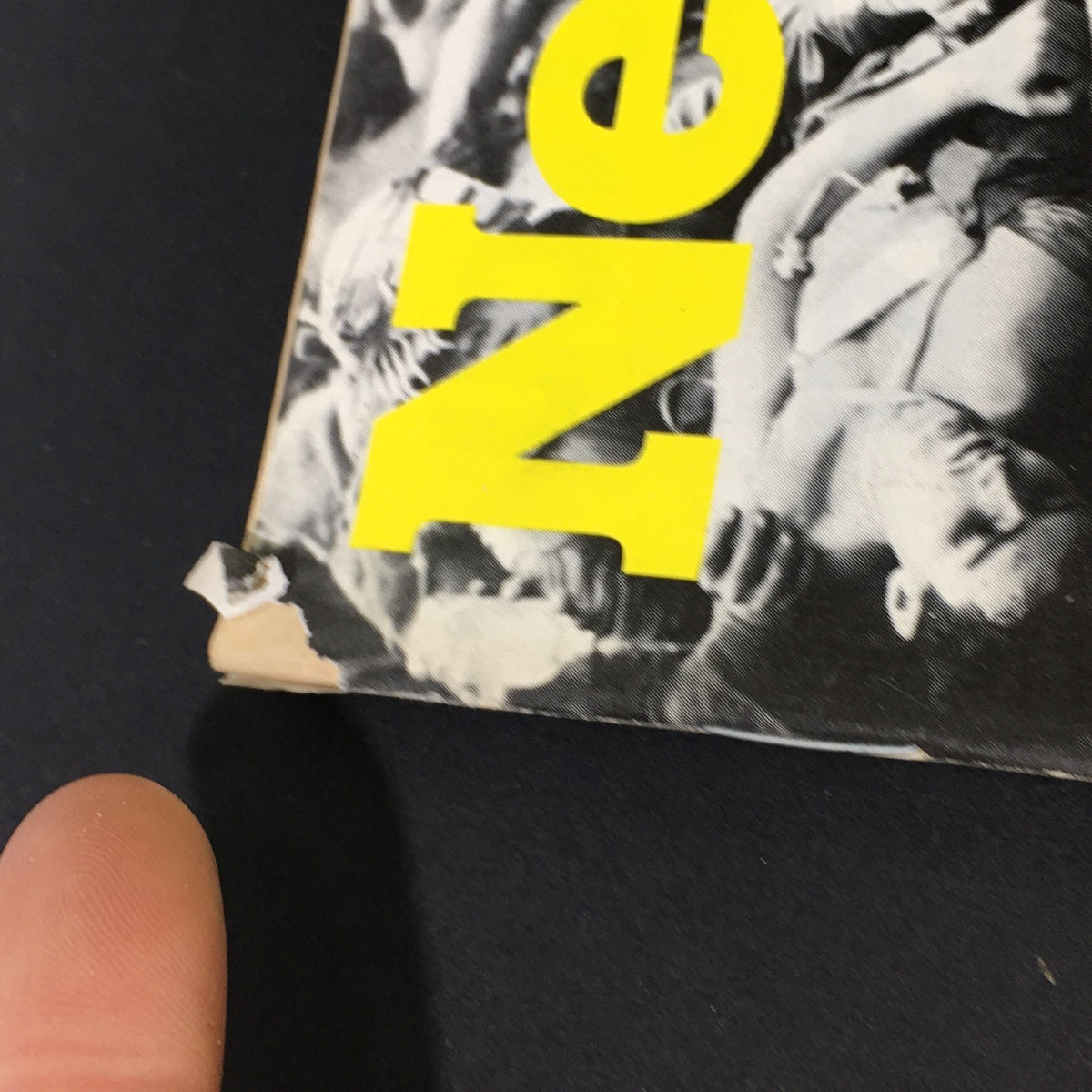 Close-up of the top corner of the vintage Newsweek magazine from May 5, 1975, showing minor wear and tear on the cover, part of the title 'Newsweek' is visible.