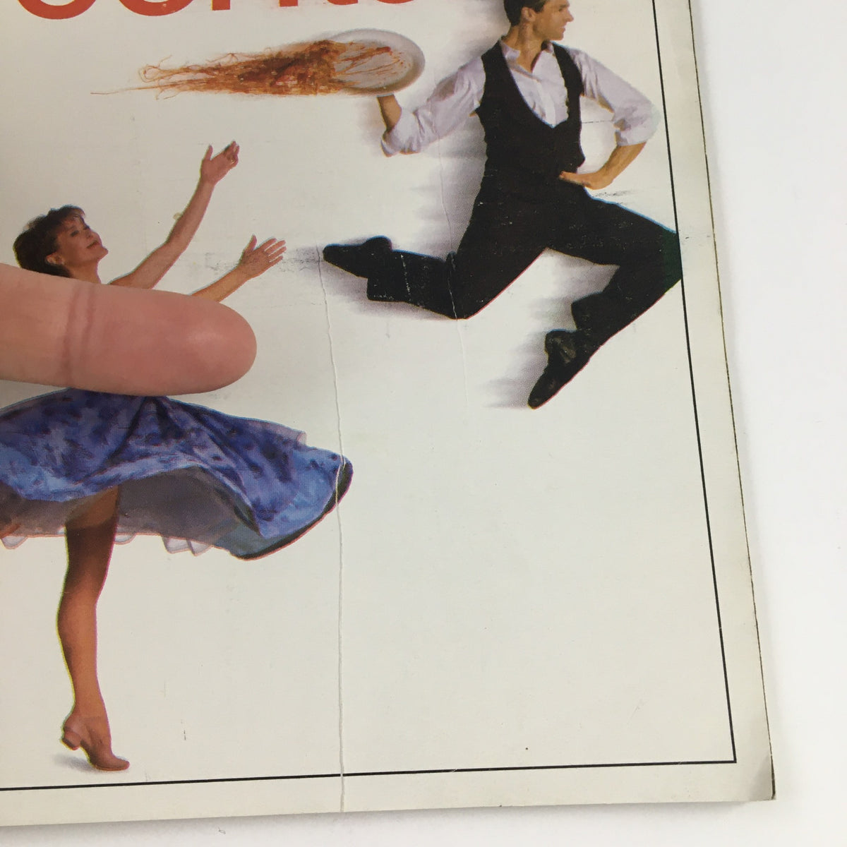 Close-up of the front cover of the 2000 Playbill Lincoln Center Theater at The Vivian Beaumont Present Contact, highlighting the creases and detail of the performers.