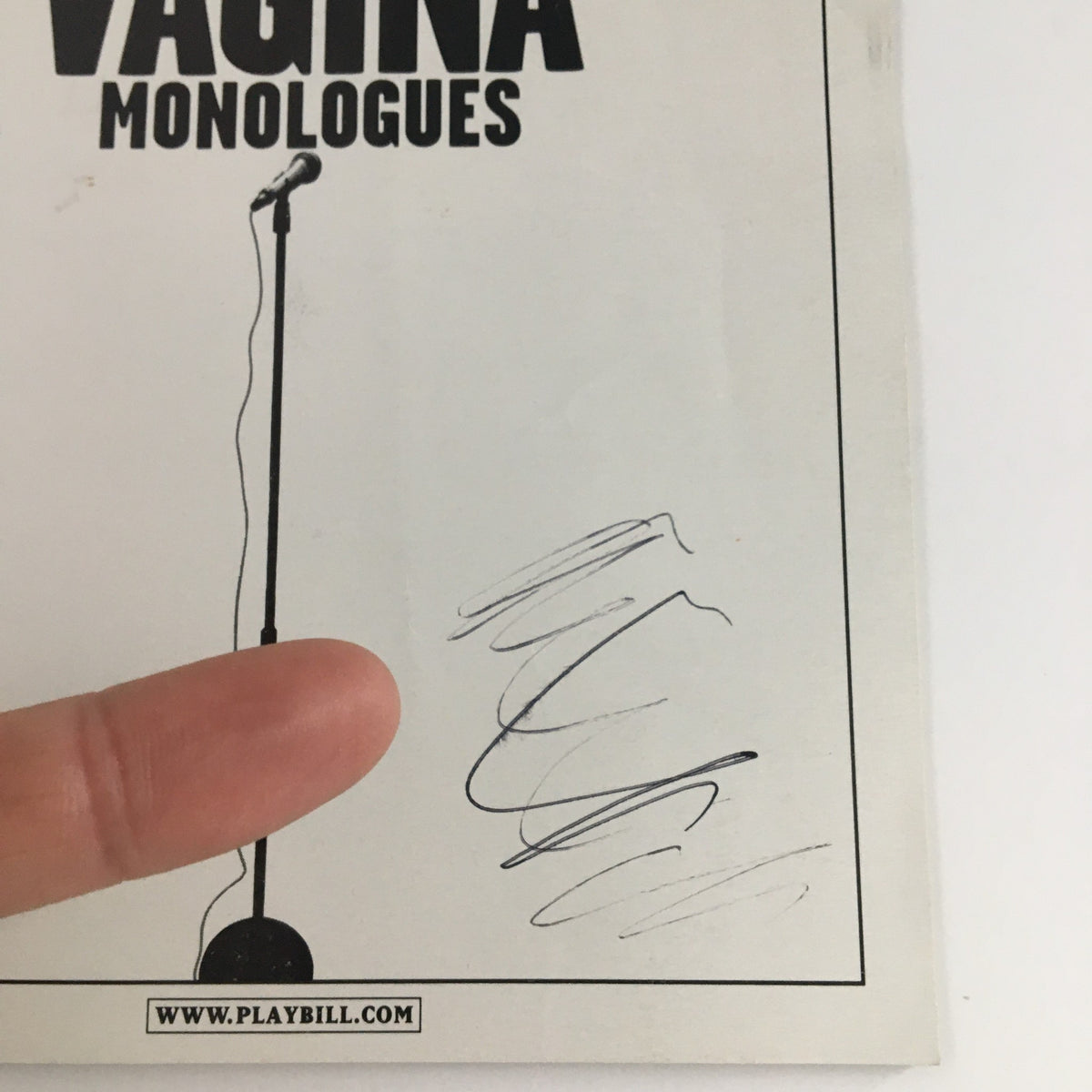 Close-up of the 2001 Playbill for The Vagina Monologues showing the title and a partially visible signature.