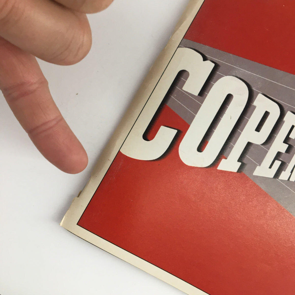 Close-up view of the worn corner of the 2000 Playbill for 'Copenhagen' at Royale Theatre, showcasing its vintage appeal.
