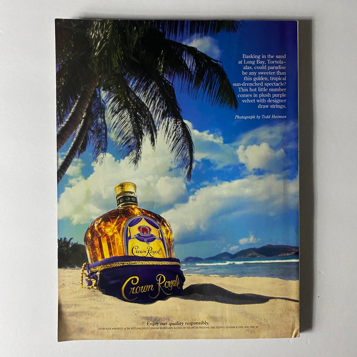 Sports Illustrated Magazine February 20 1998 ad page featuring a bottle of Crown Royal whiskey on a tropical beach, highlighting vintage branding and lifestyle aesthetics from the magazine era.
