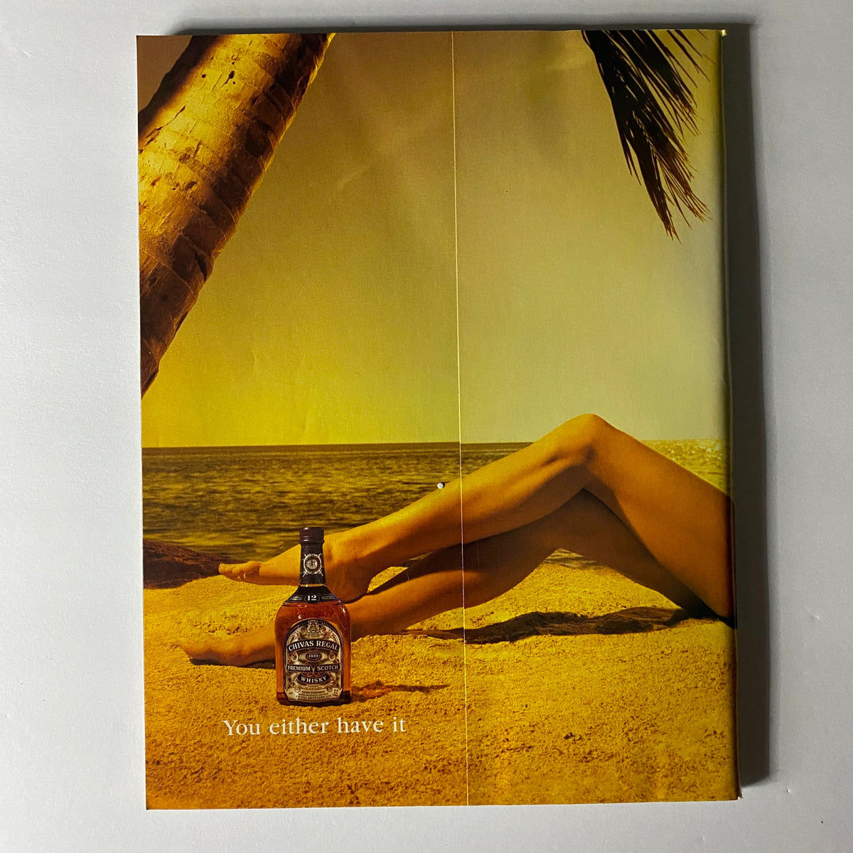 Back cover of Sports Illustrated Winter 1997 Magazine, showcasing a creative advertisement with a beach scene and a prominent bottle, emphasizing lifestyle and luxury themes.