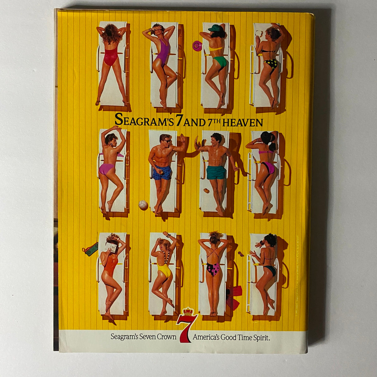 Seagram's 7 advertising magazine showcasing a vibrant beach scene with models in various swimsuits, promoting summer and fun.