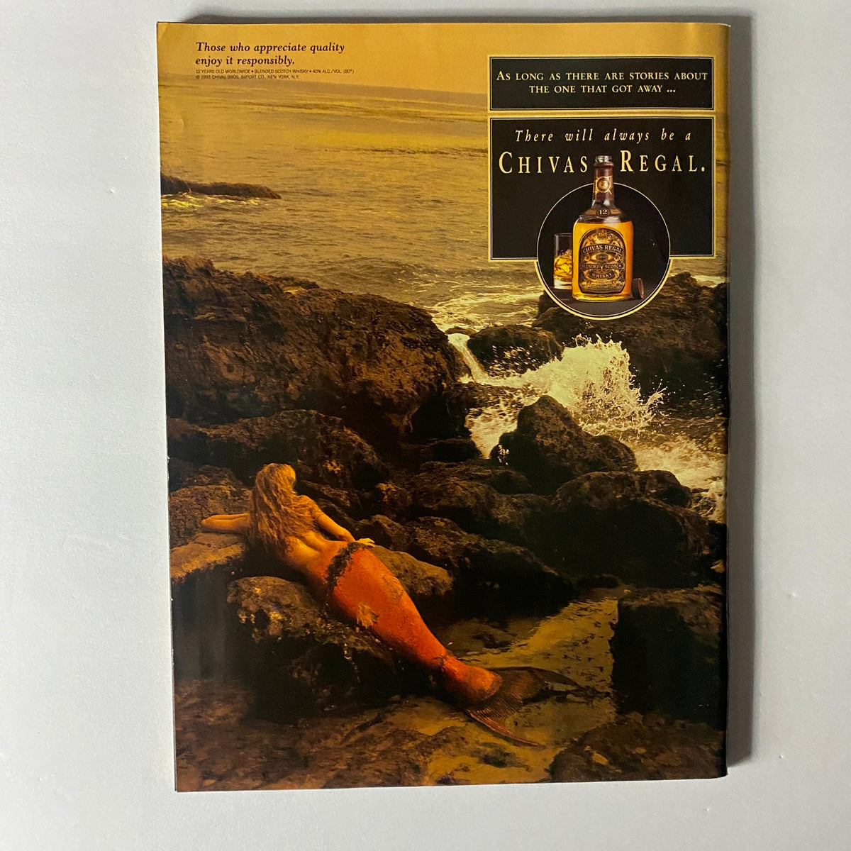 Classic advertisement in Sports Illustrated Magazine February 14, 1994 for Chivas Regal. The ad features a beautiful mermaid resting on rocky coastlines, evoking a sense of storytelling and luxury.