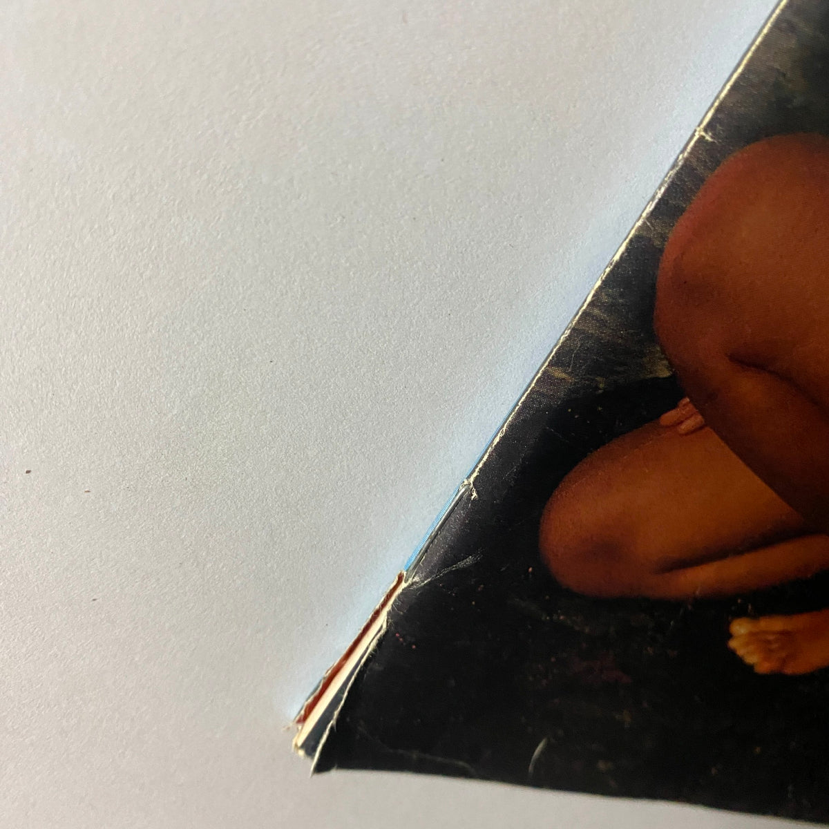 Close-up of the edge of a vintage Sports Illustrated magazine from February 13, 1984, featuring Paulina Porizkova on the cover. This image captures slight wear typical for its age.