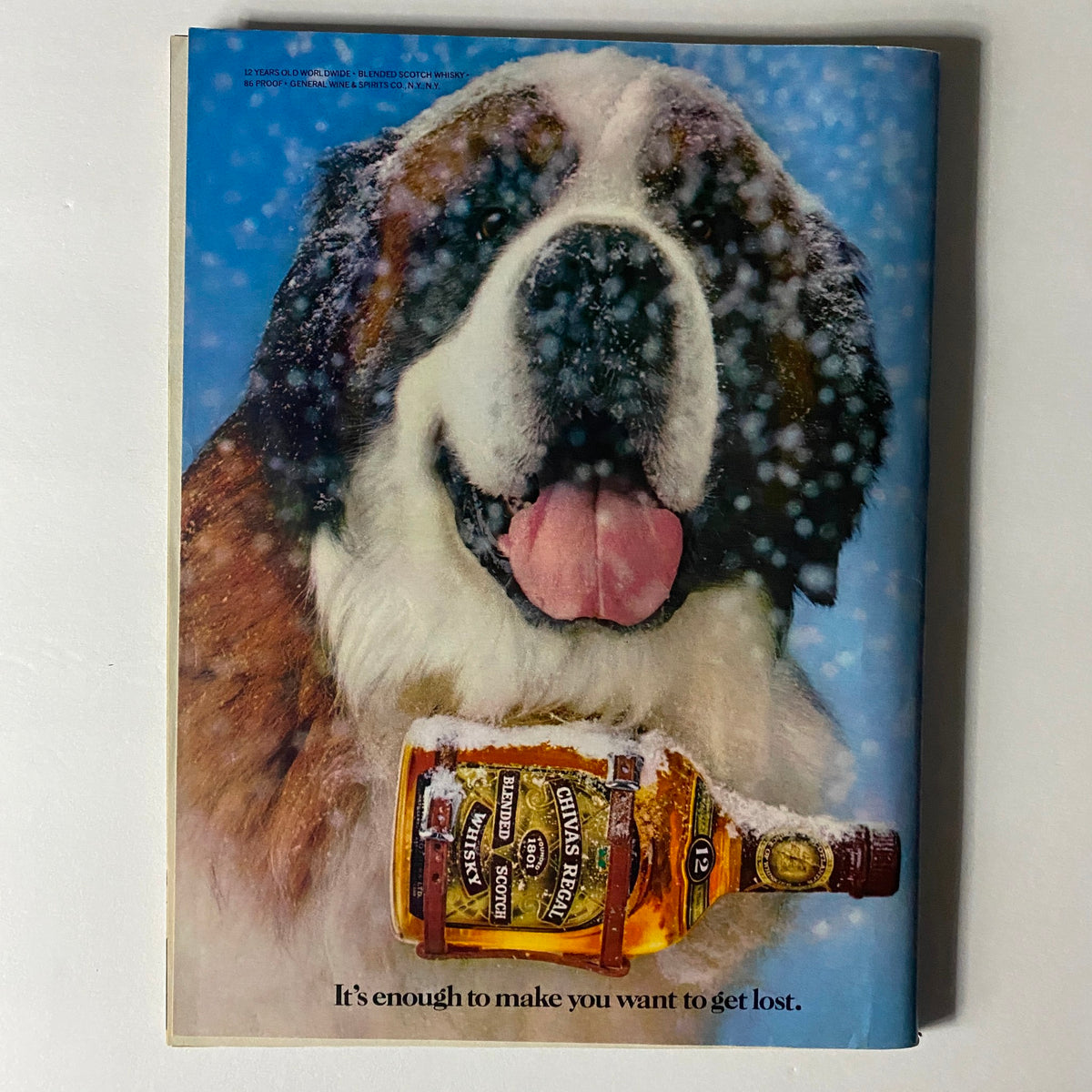 Vintage Sports Illustrated Magazine cover from February 11, 1985 featuring a snowy St. Bernard dog and a bottle of Chivas Regal whisky, illustrating the nostalgic charm of the era and captivating the essence of sports and culture.