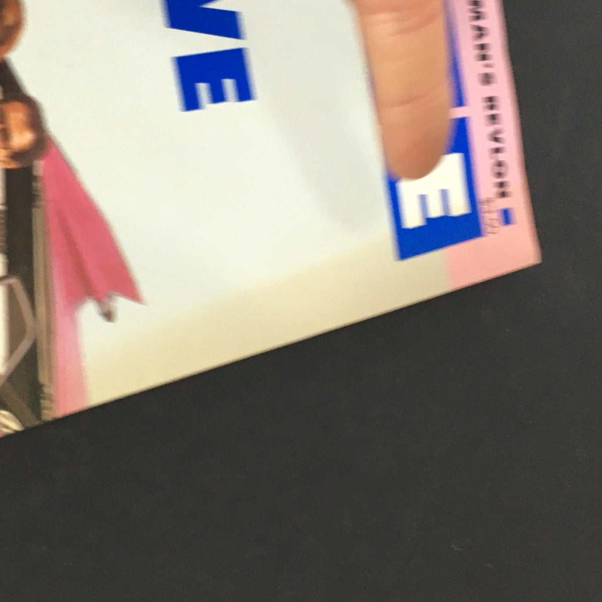 Detail view of a finger indicating the title section on the cover of the vintage Fortune Magazine from September 14, 1987, highlighting Apple and Perelman's Revlon.