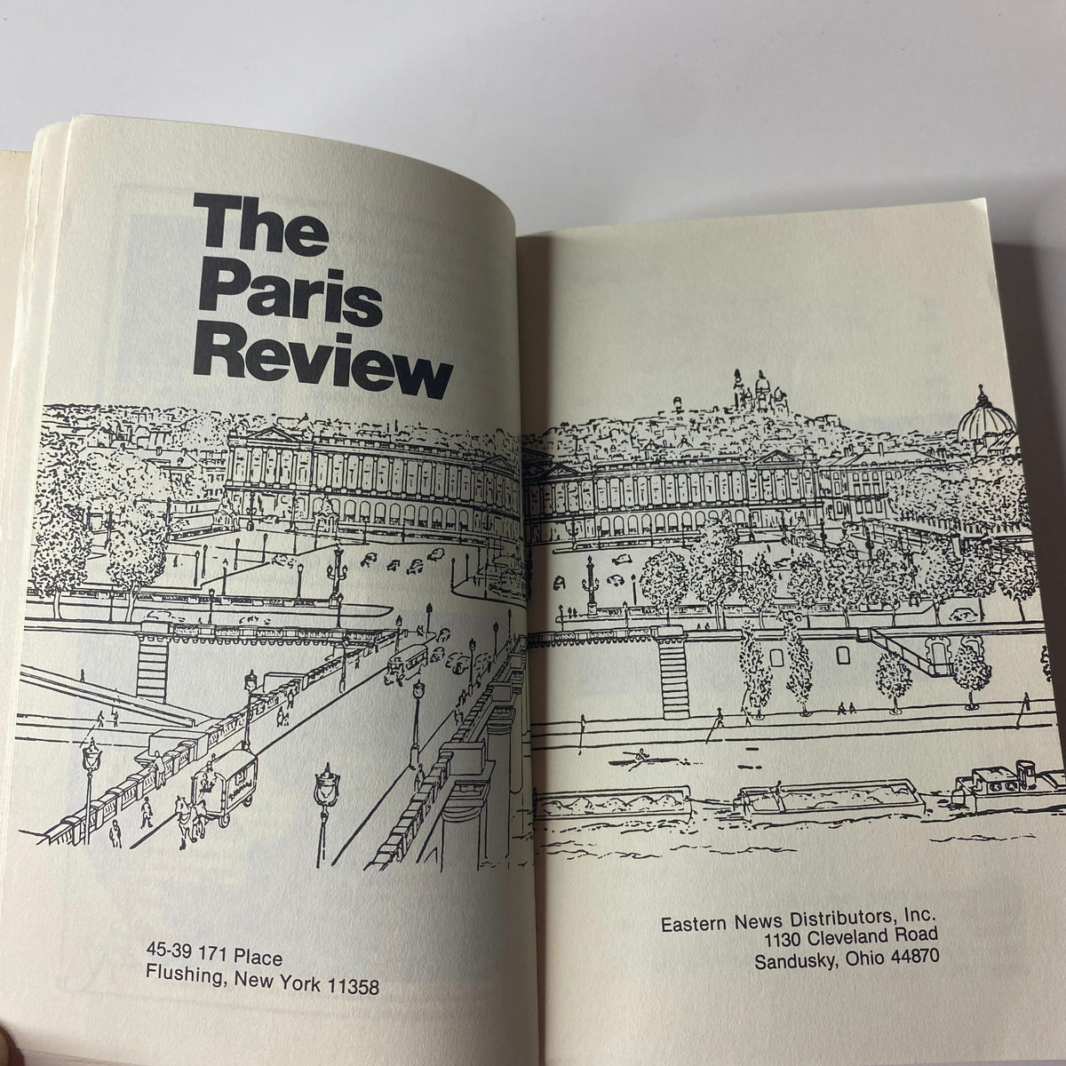 Inside page of The Paris Review Magazine Fall 1992 No. 124 displaying the title and details of Eastern News Distributors, with a sketch of a scenic view.
