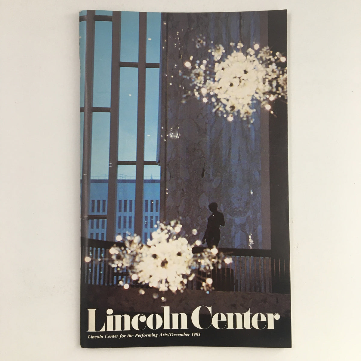 1983 Stagebill for Lincoln Center featuring A Critic's Best Friend by Marilyn Stasio, showcasing a stylish interior with chandeliers and a silhouette of a person in a grand setting.