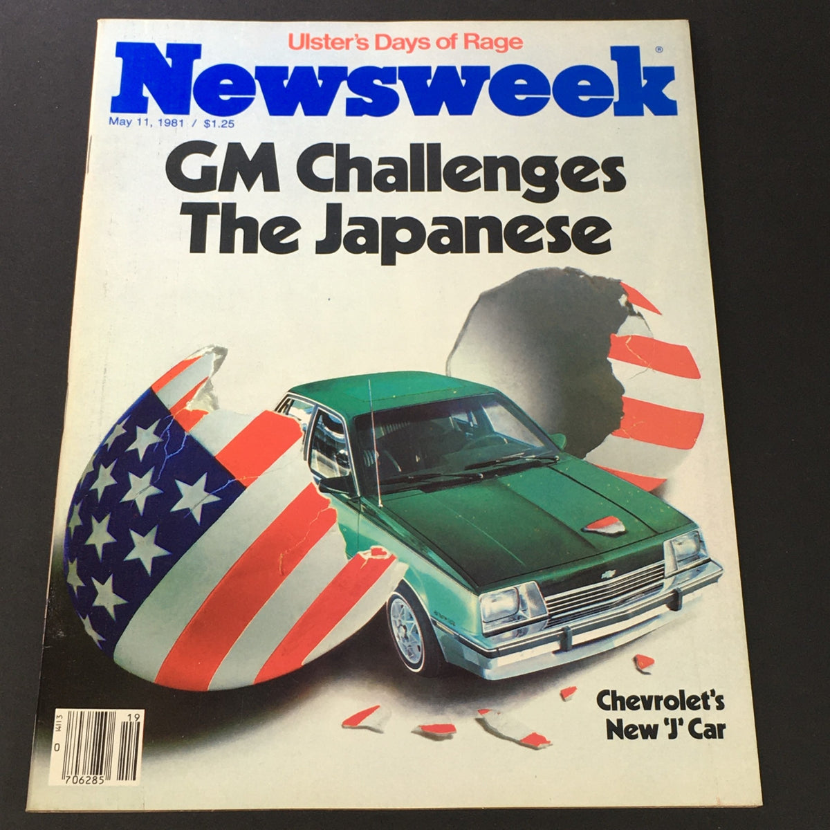 Cover of Newsweek magazine from May 11, 1981, featuring the title 'GM Challenges The Japanese' and an image of a green car breaking through a shell adorned with the American flag. The cover also mentions 'Ulster's Days of Rage' and highlights Chevy's new 'J' car.