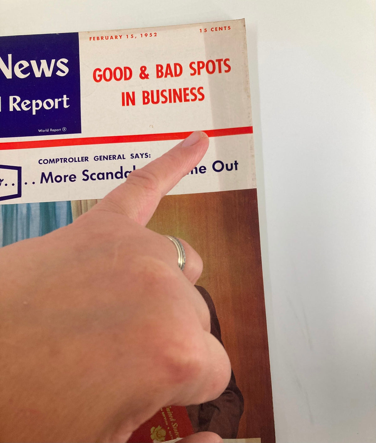 Close-up view of the cover of US News & World Report Magazine February 15, 1952, highlighting the title Good & Bad Spots in Business with a finger pointing at the headline.