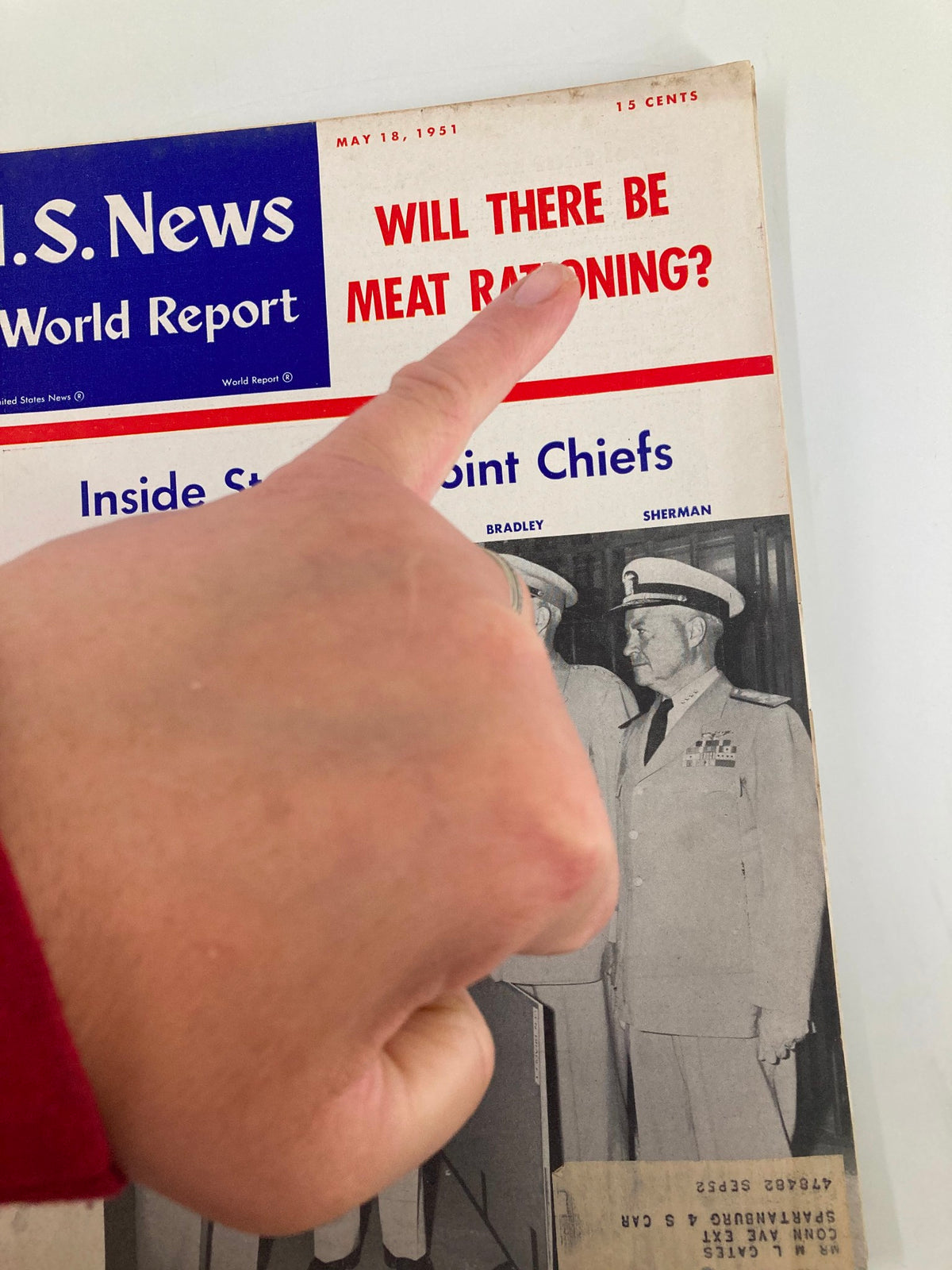 Close-up of US News & World Report Magazine cover from May 18, 1951, highlighting the question 'WILL THERE BE MEAT RATIONING?' while showcasing a hand pointing at the headline.