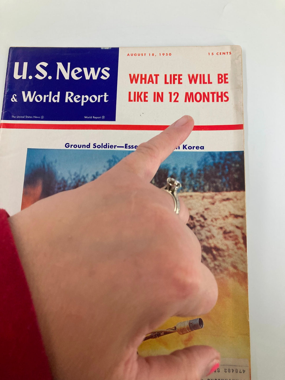 Close-up of US News & World Report Magazine August 18, 1950 showing the cover headline 'What Life Will Be Like in 12 Months' and highlighting the story on the essential role of soldiers in Korea.