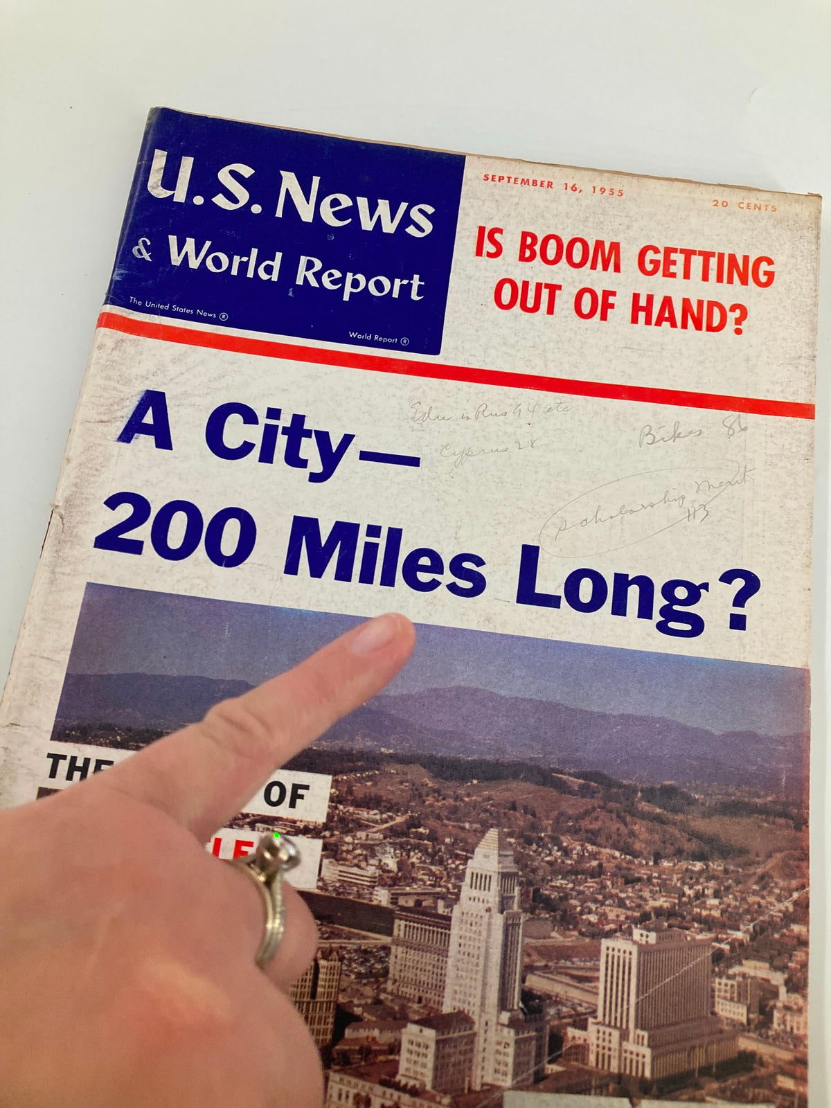 Close-up of the US News & World Report Magazine cover from September 16, 1955, showing the headline 'Is Boom Getting Out of Hand?' with a hand pointing to the title 'A City - 200 Miles Long?'
