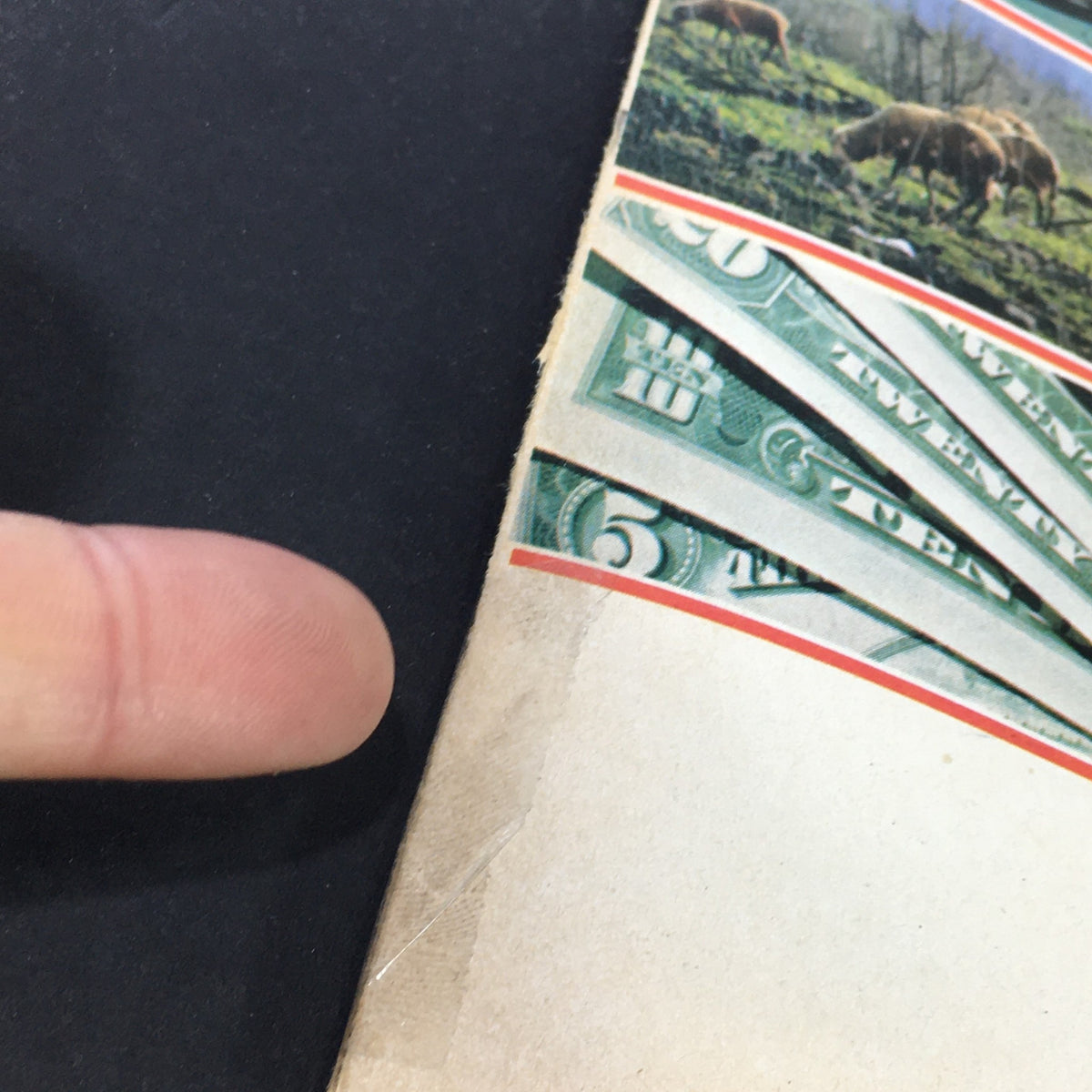 Close-up detail of the vintage U.S. News & World Report January 2, 1978 depicting the edge of the magazine with visible wear and a finger pointing at the section featuring financial topics.