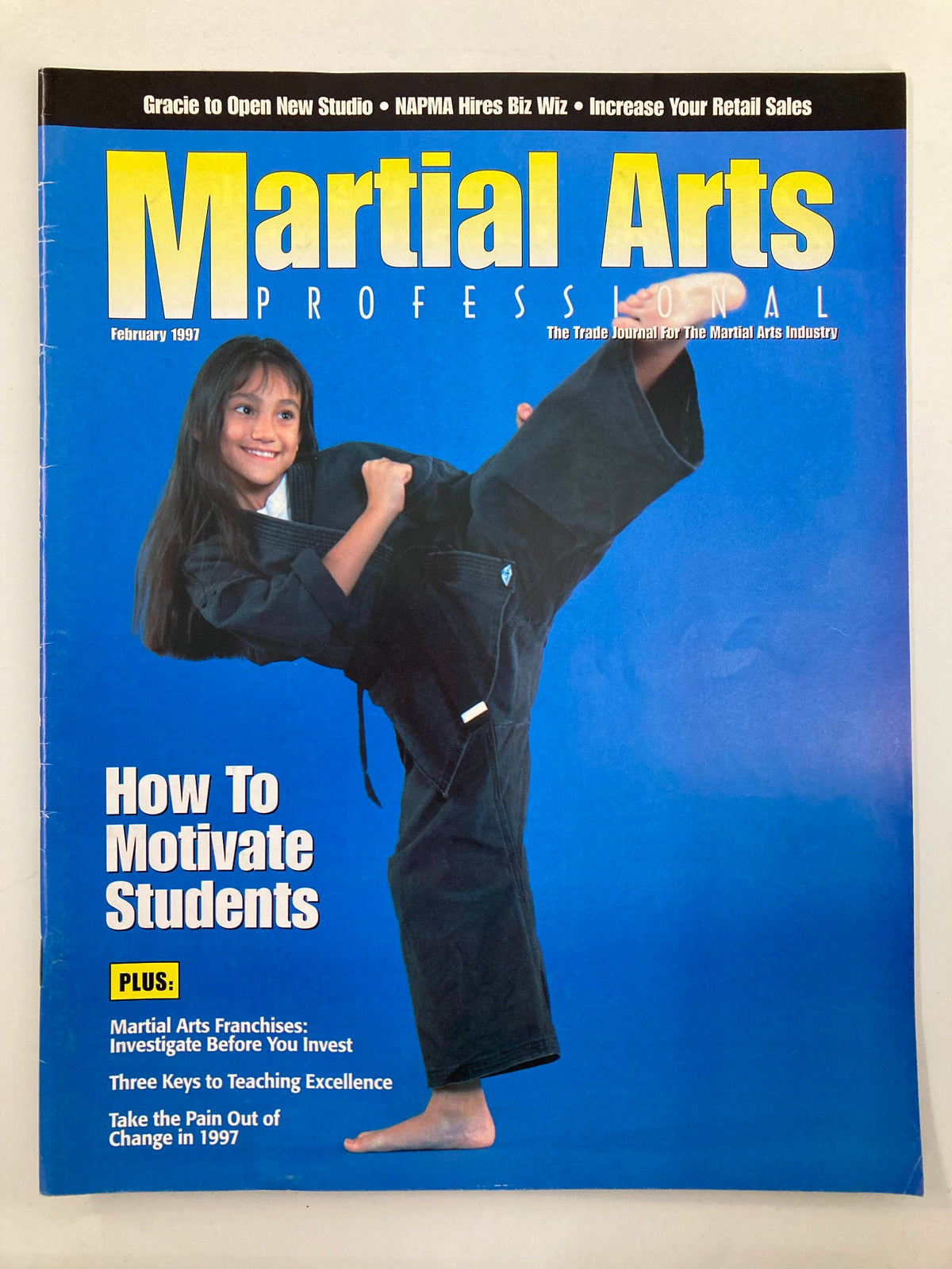 Cover of Martial Arts Professional February 1997 focusing on 'How To Motivate Students' with a young girl posing in a martial arts uniform.
