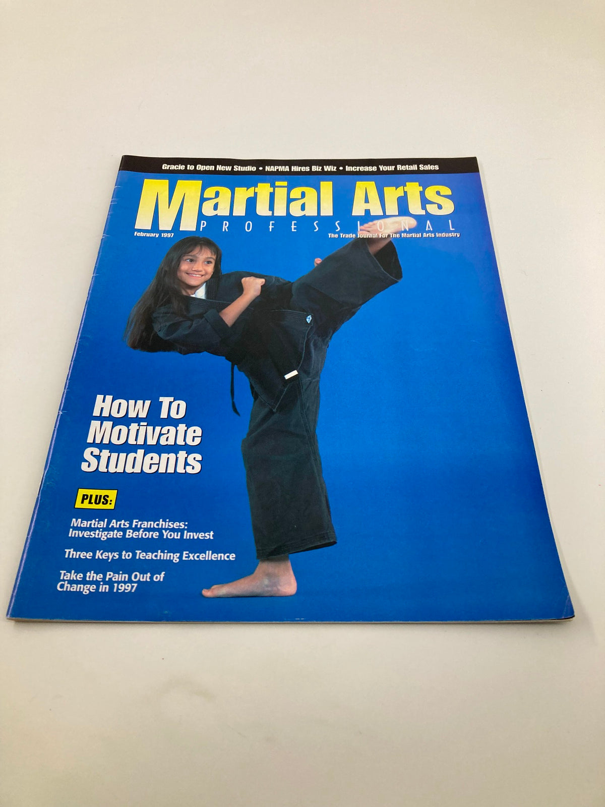 Front cover of Martial Arts Professional February 1997 showcasing 'How To Motivate Students' with an image of a young female martial artist.
