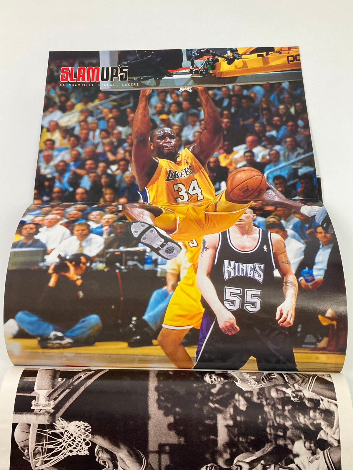 Poster from Slam Magazine December 2001 #56 showcasing a dynamic basketball play with a player from the Los Angeles Lakers, celebrating the essence of basketball culture.