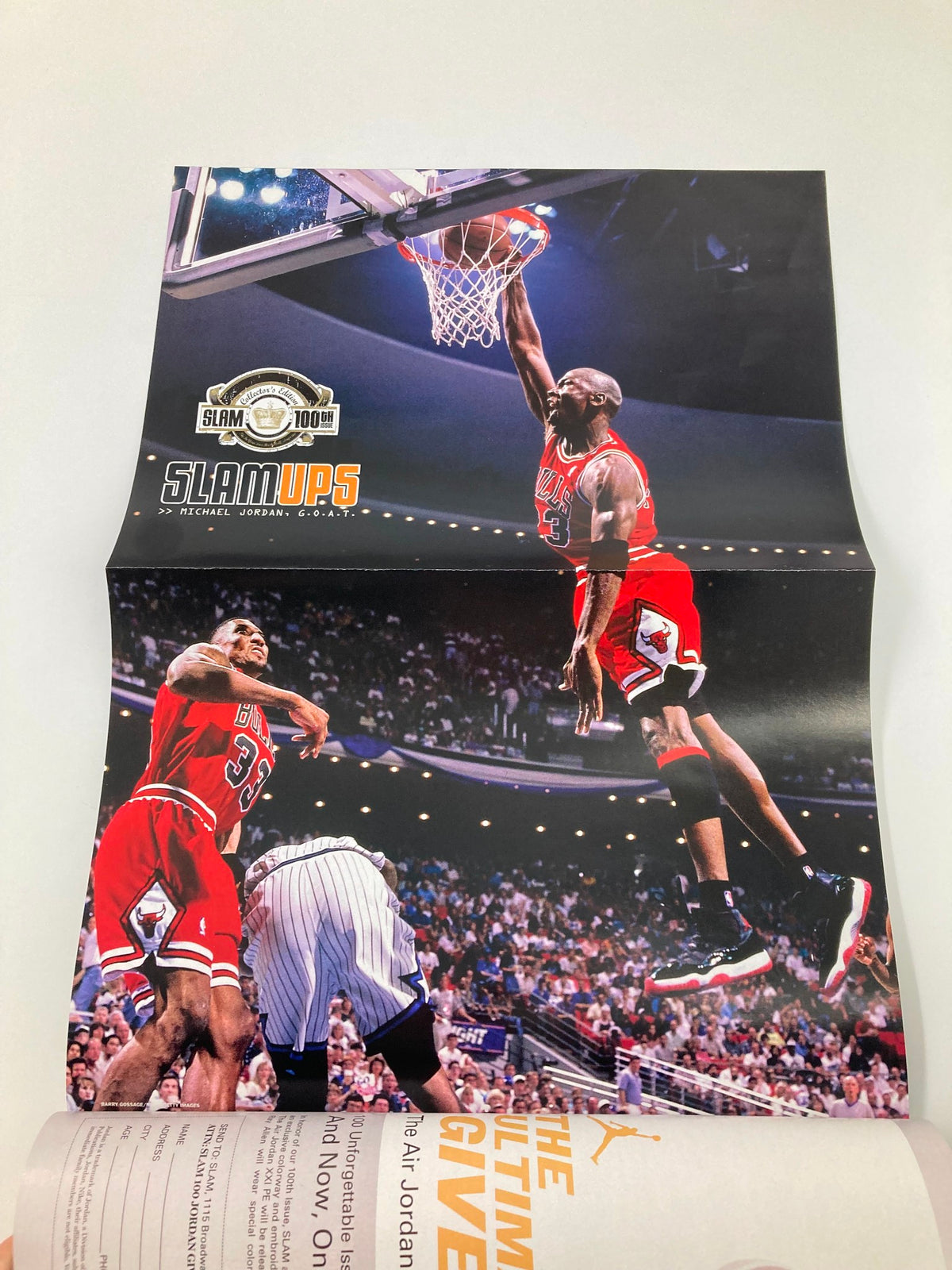 Fold-out page from Slam Magazine August 2006 #100 featuring a dynamic image of Michael Jordan making an impressive dunk, capturing his athleticism.