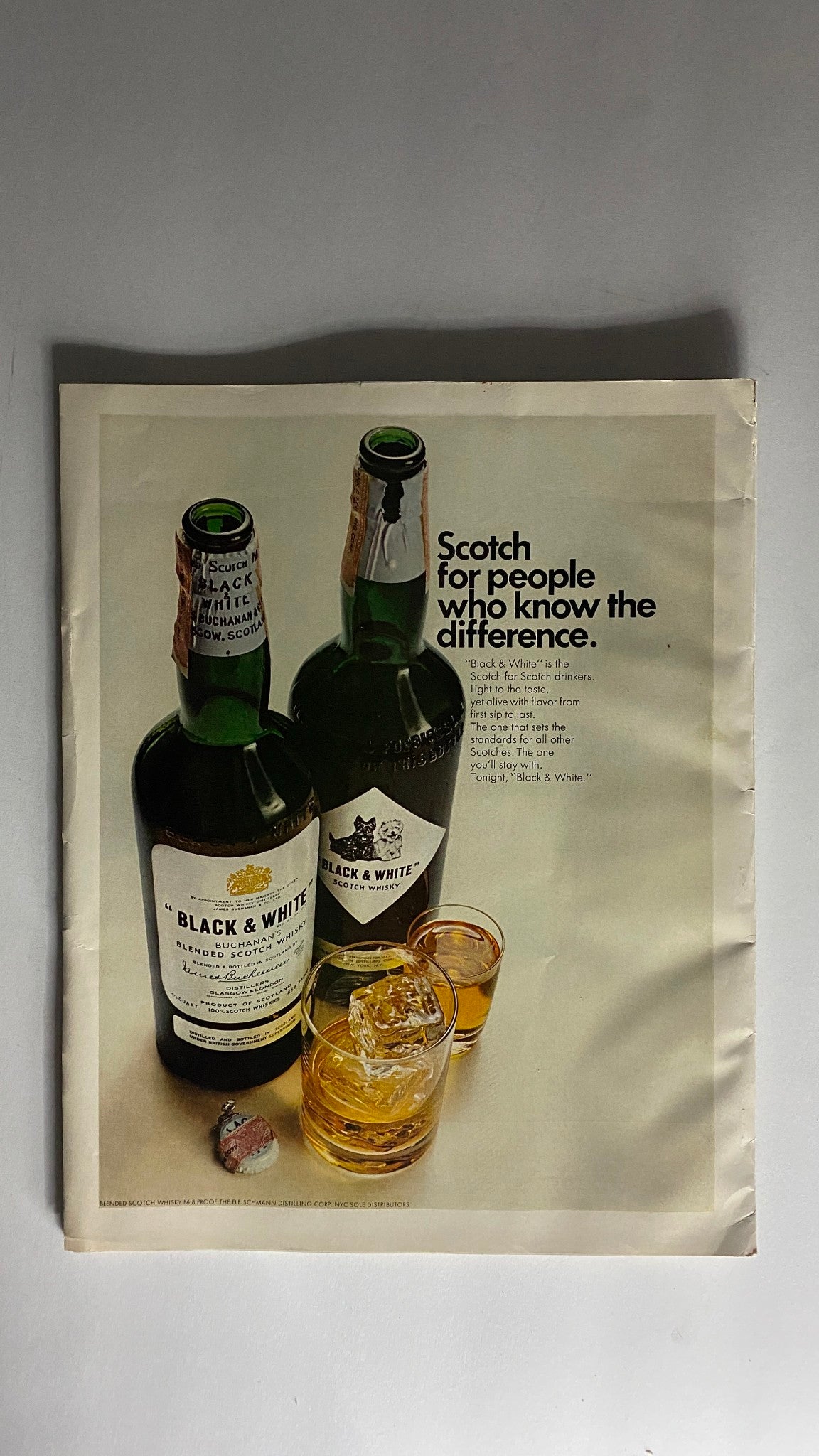 Advertisement from VTG Holiday Magazine April 1967, promoting Black & White Scotch whisky with branding and product imagery.