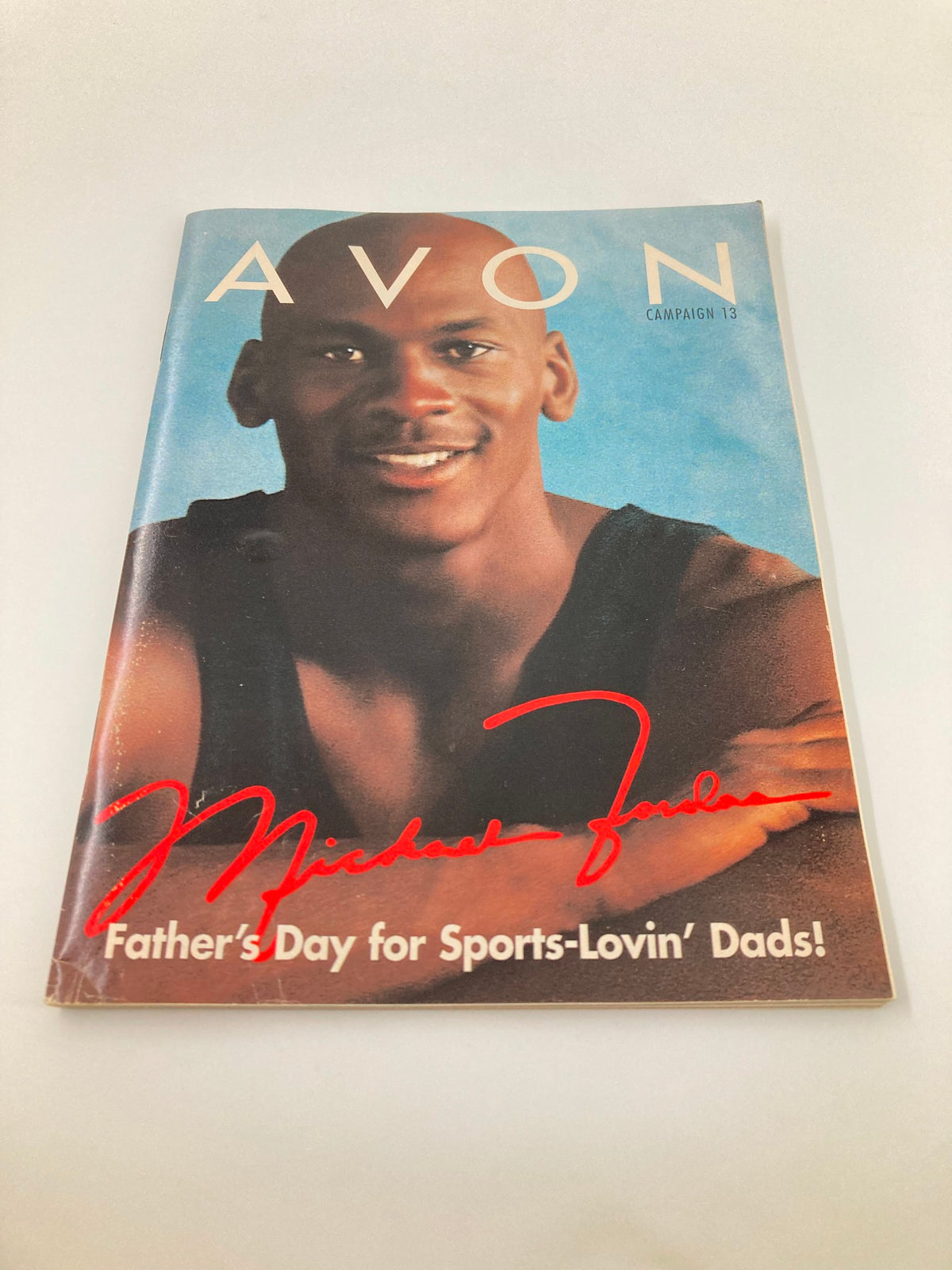 1997 Avon Campaign 13 Brochure showcasing Michael Jordan's Father's Day special, depicting a nostalgic marketing piece with striking visuals and signature.