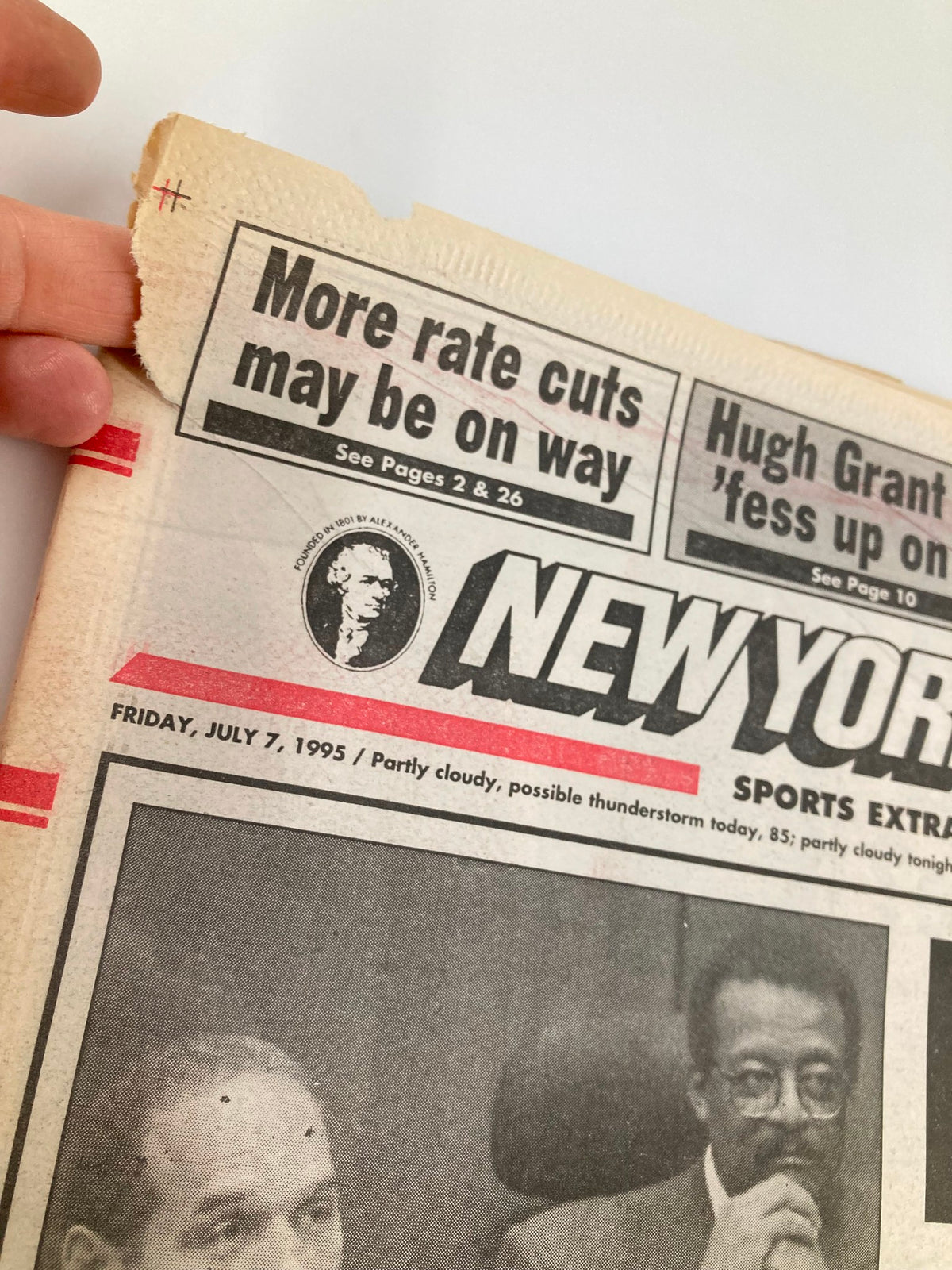 Close-up of the top section of the New York Post Newspaper from July 7, 1995, with headlines about upcoming news and date, emphasizing its collectible nature.