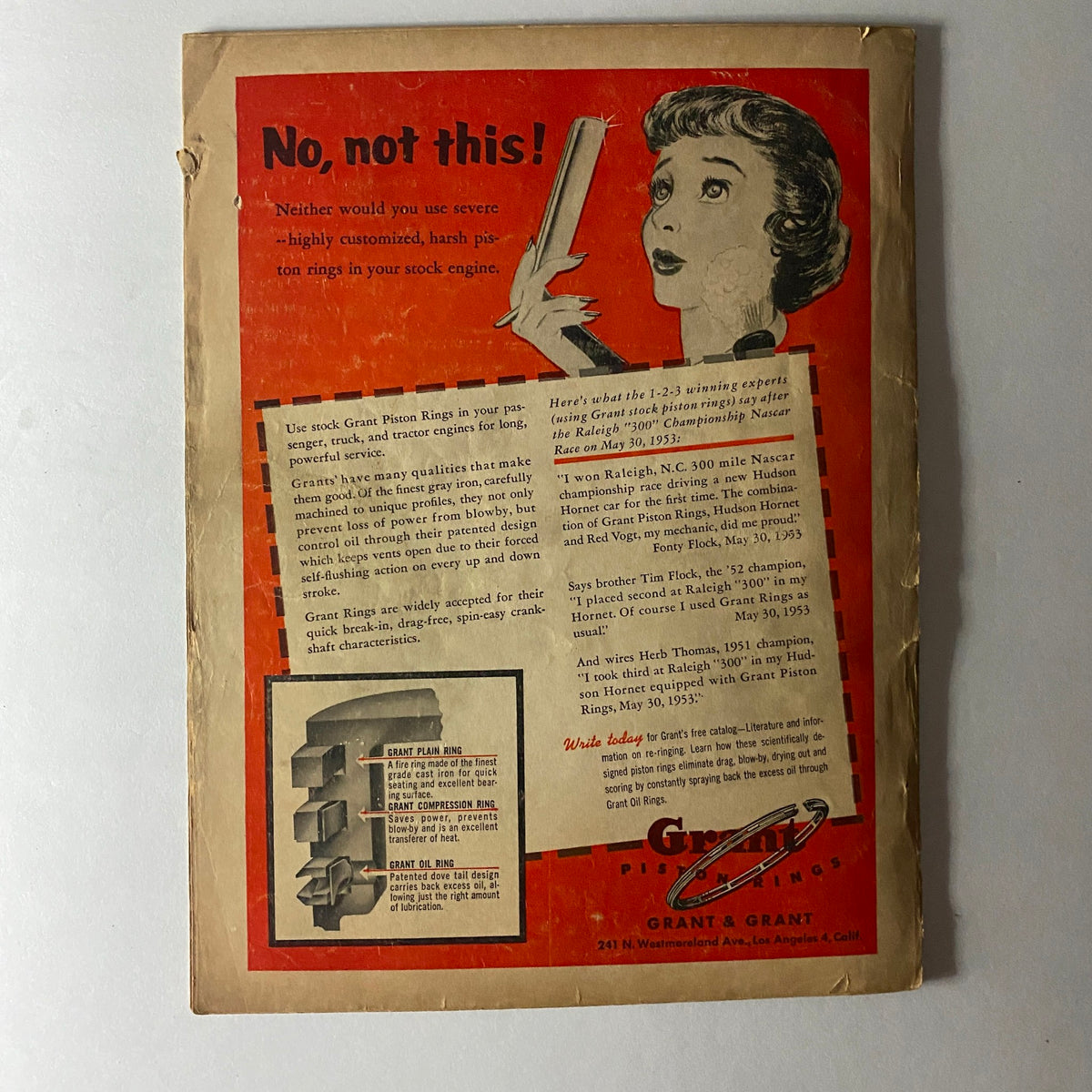 Back cover of VTG Hot Rod Magazine September 1953 featuring an advertisement for Grant Piston Rings with a woman holding a piston ring.