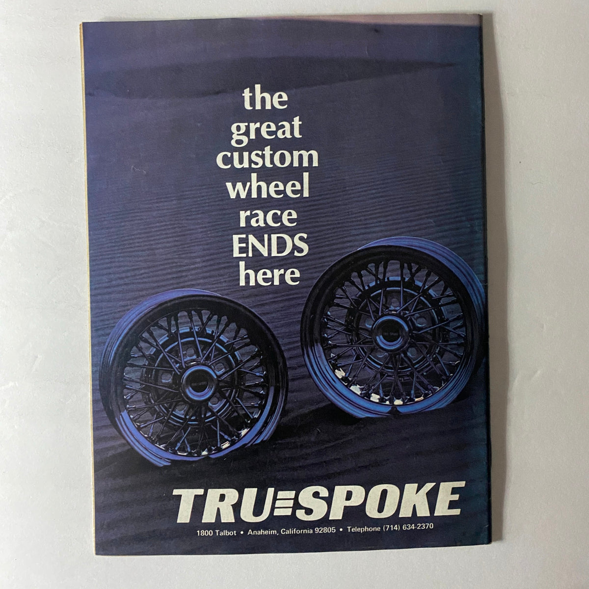 Cover of VTG Truckin' Magazine April 1976 featuring the great custom wheel race, showcasing two custom wheels with the title "the great custom wheel race ENDS here" and branding of TRU-SPOKE.