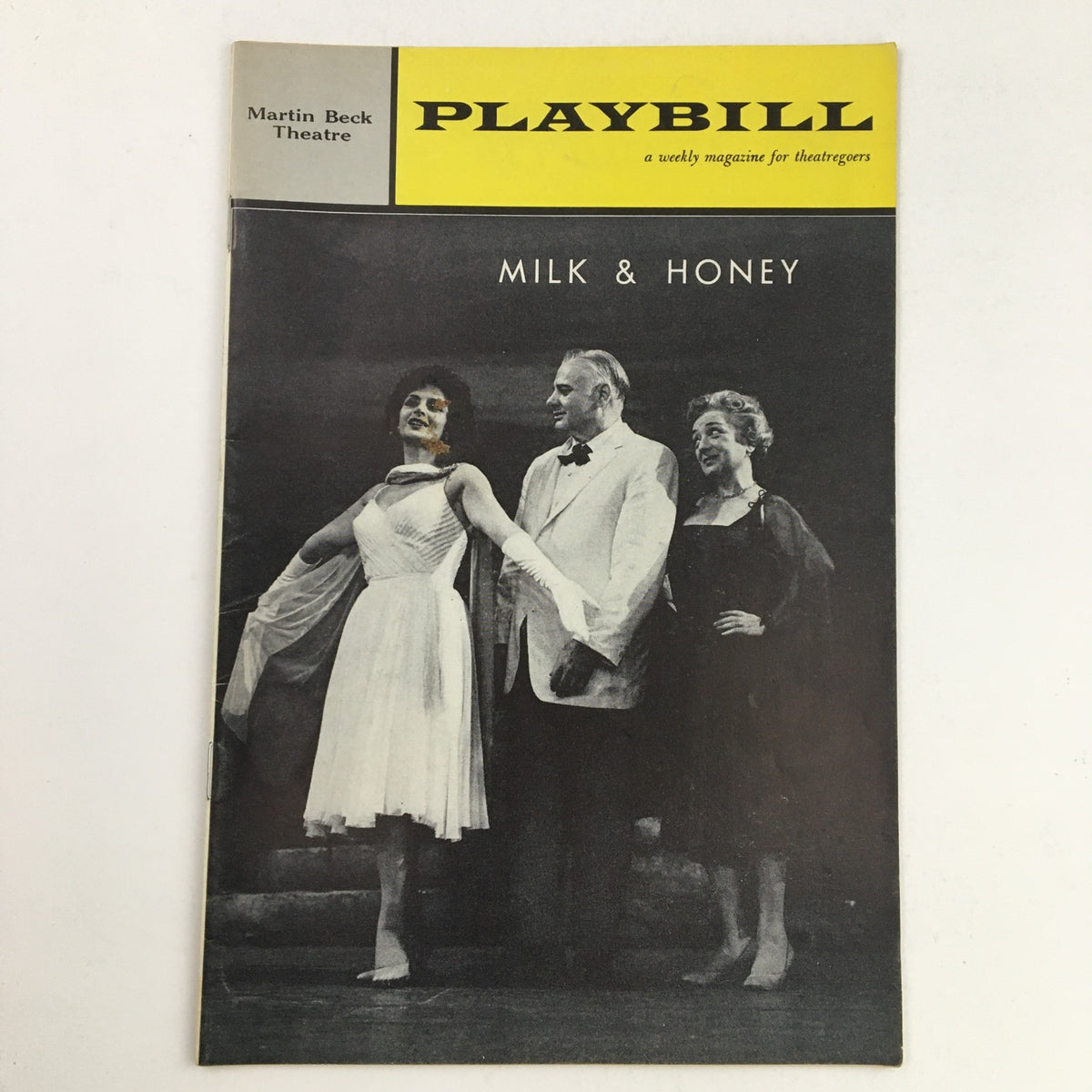 1962 Playbill for the musical Milk and Honey, featuring performers on stage at Martin Beck Theatre, showcasing vintage Broadway style.